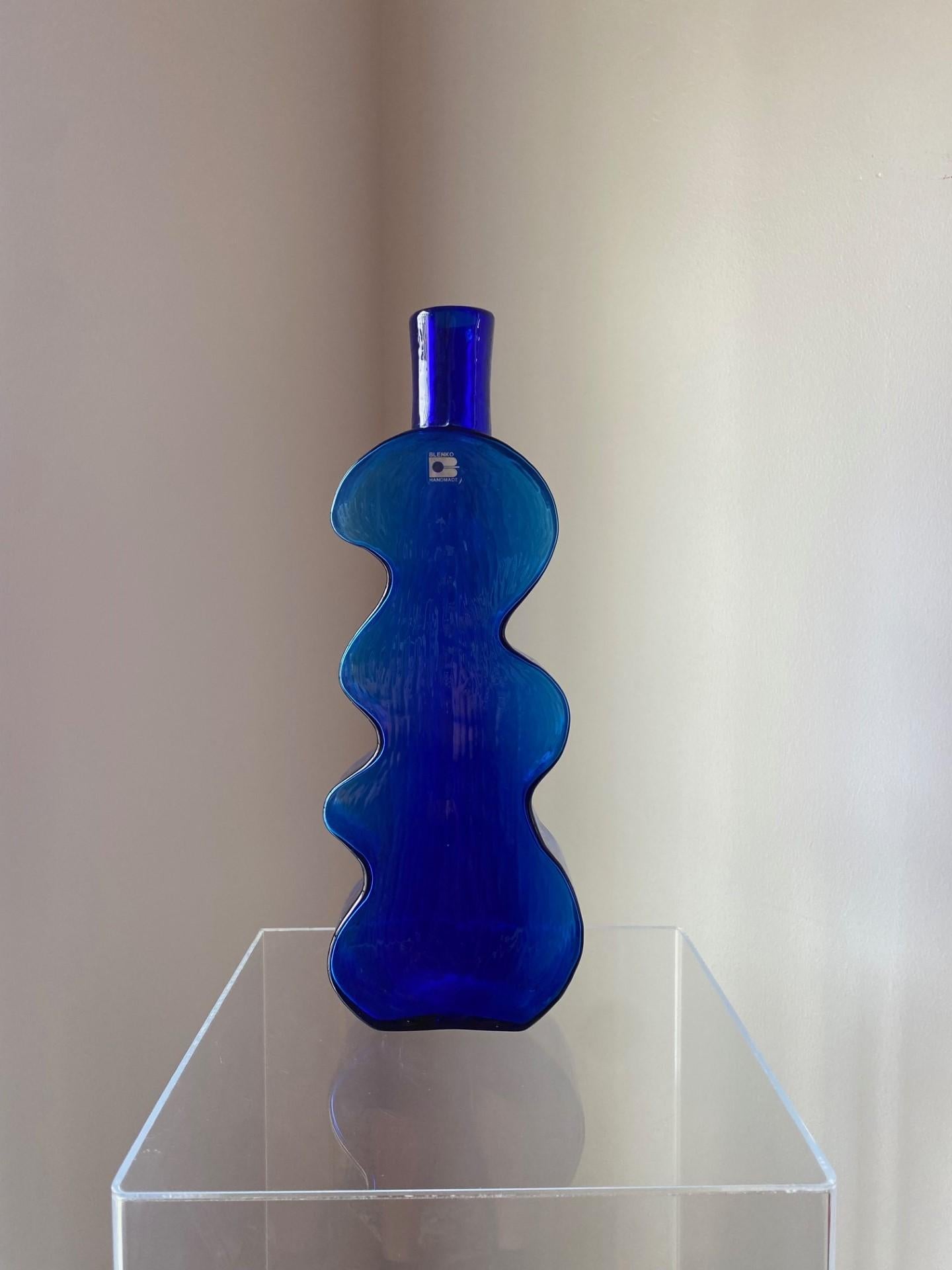 Vintage and unique piece. Beautiful art glass vase shaped as a puzzle piece by Blenko. This glass vase is sculptural and evocative. The beautifully crafted glass is shaped to capture form and style. The glass is pristine and decadent in a deep blue