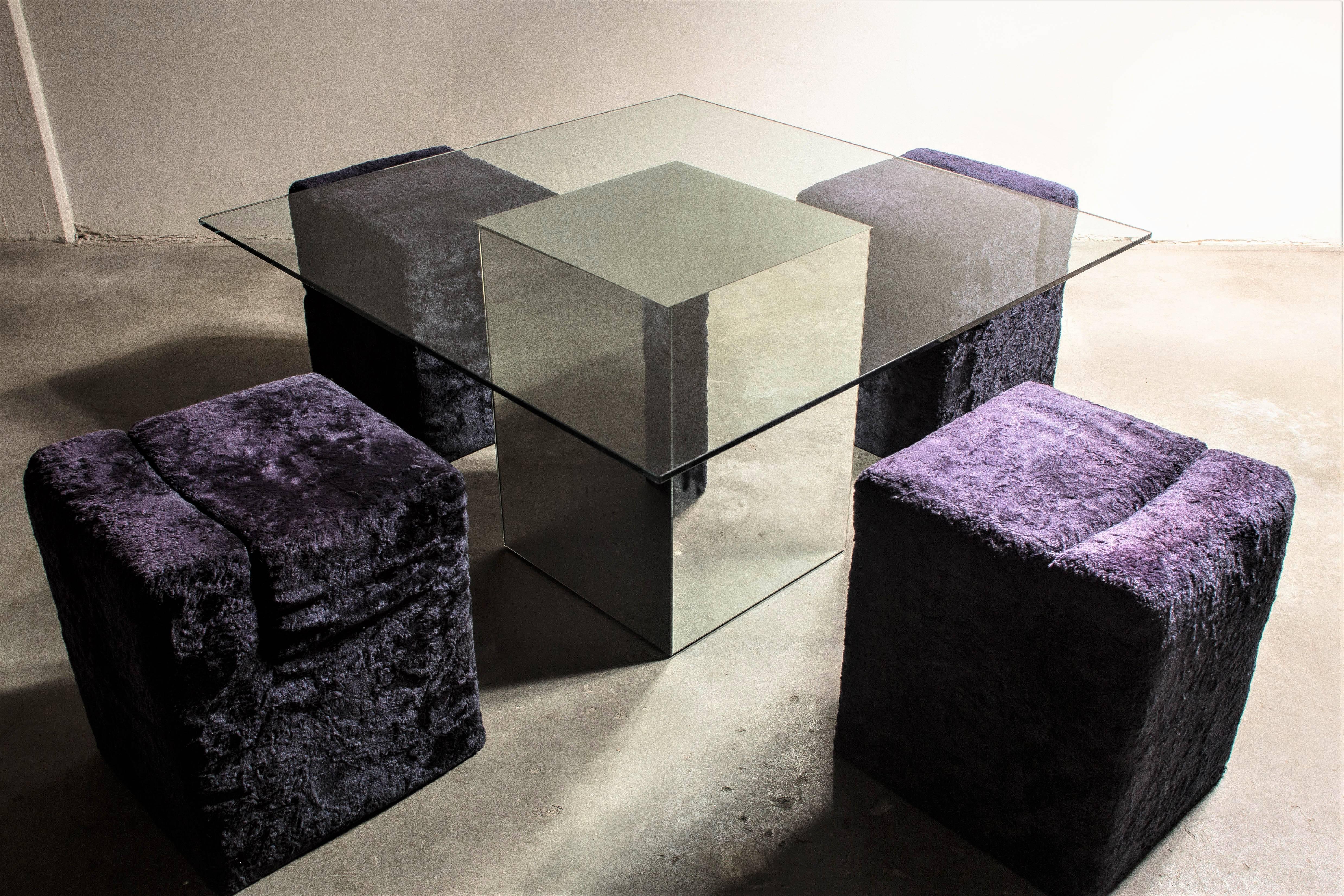 “Blok” dining table designed by Nanda Vigo for Acerbis 1971. Square tabletop with central base consisting of a mirrored glass removable “Block” (attached by articulated hinges). The glass top rests on the block via a guard rail that guarantees