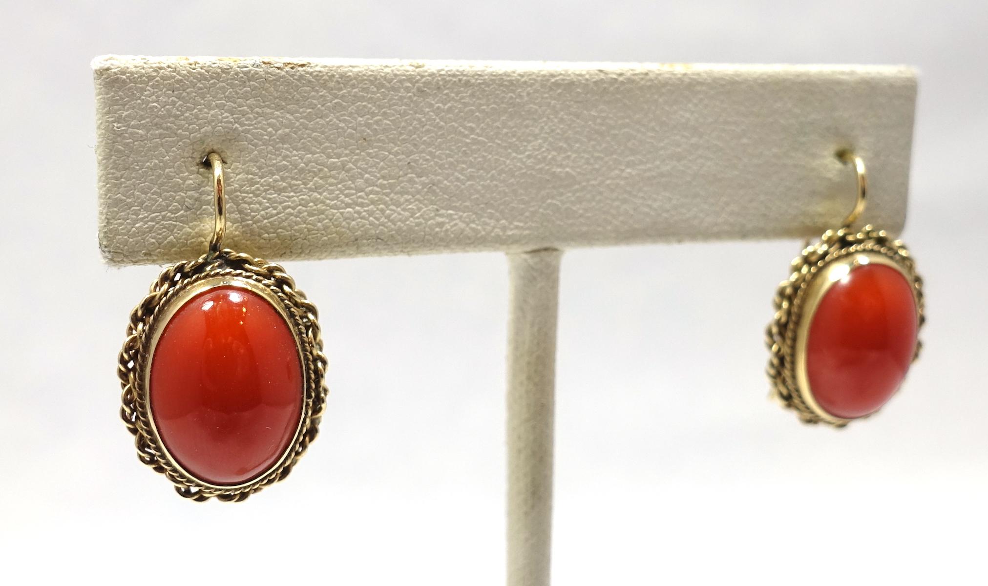 These vintage earrings feature cabochon blood coral stones in a 14kt gold setting.  These pierced earrings measure 3/4” x 5/8” and are in excellent condition.