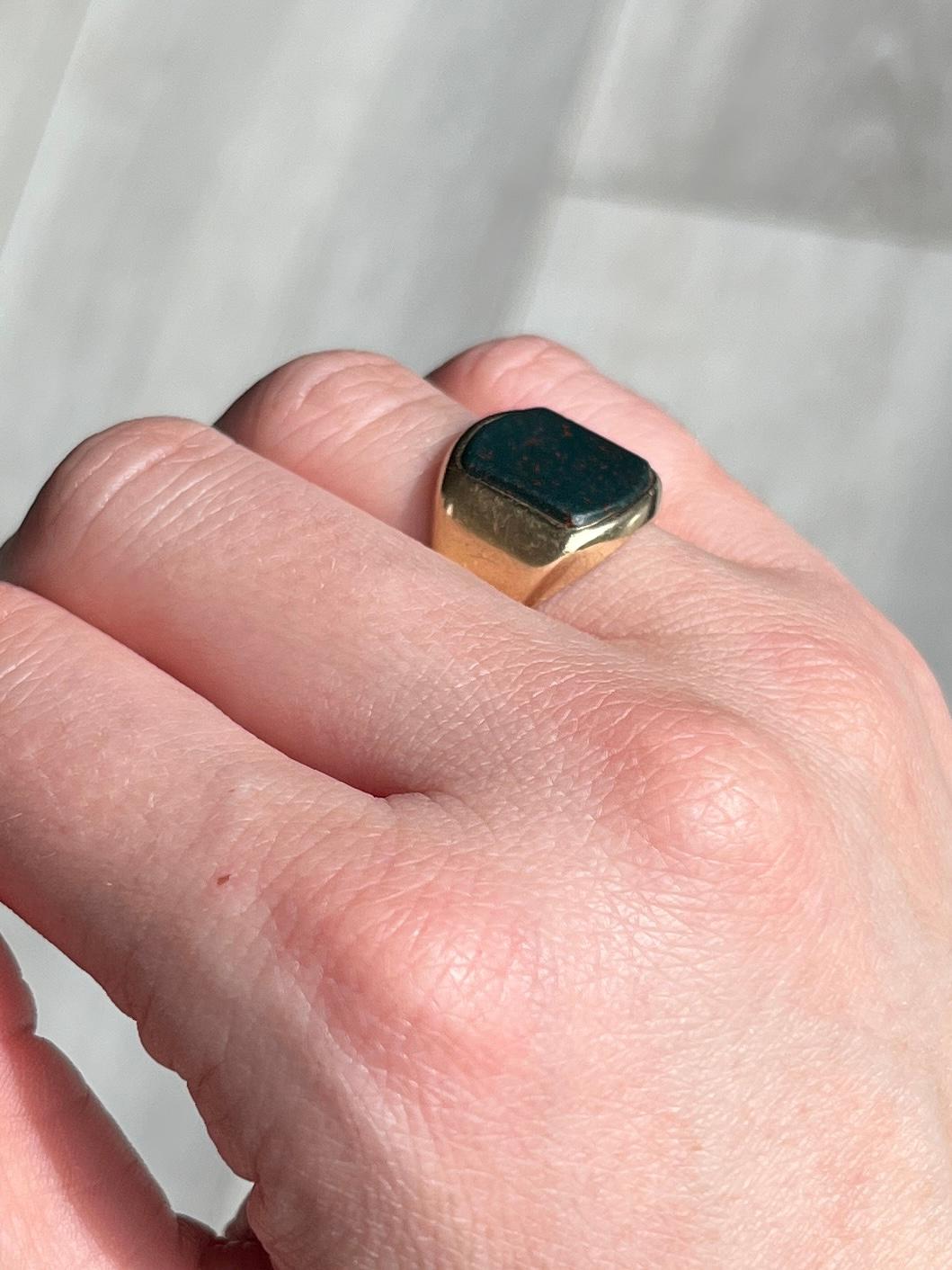 This gorgeous signet ring has a bloodstone set within the 9carat gold band. The stone is deep green with flecks of red running through. Fully hallmarked Birmingham 1971.

Ring Size: J 1/2 or 5
Stone dimensions: 12x11mm 

Weight: 6.8g 