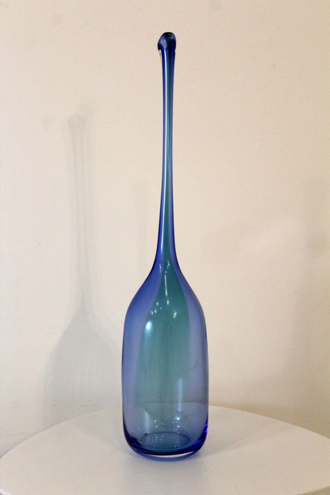 For your consideration is this show stopping blue glass vessel by Nouvel. Dimensions: 4.5 diameter x 22.25 height.
    