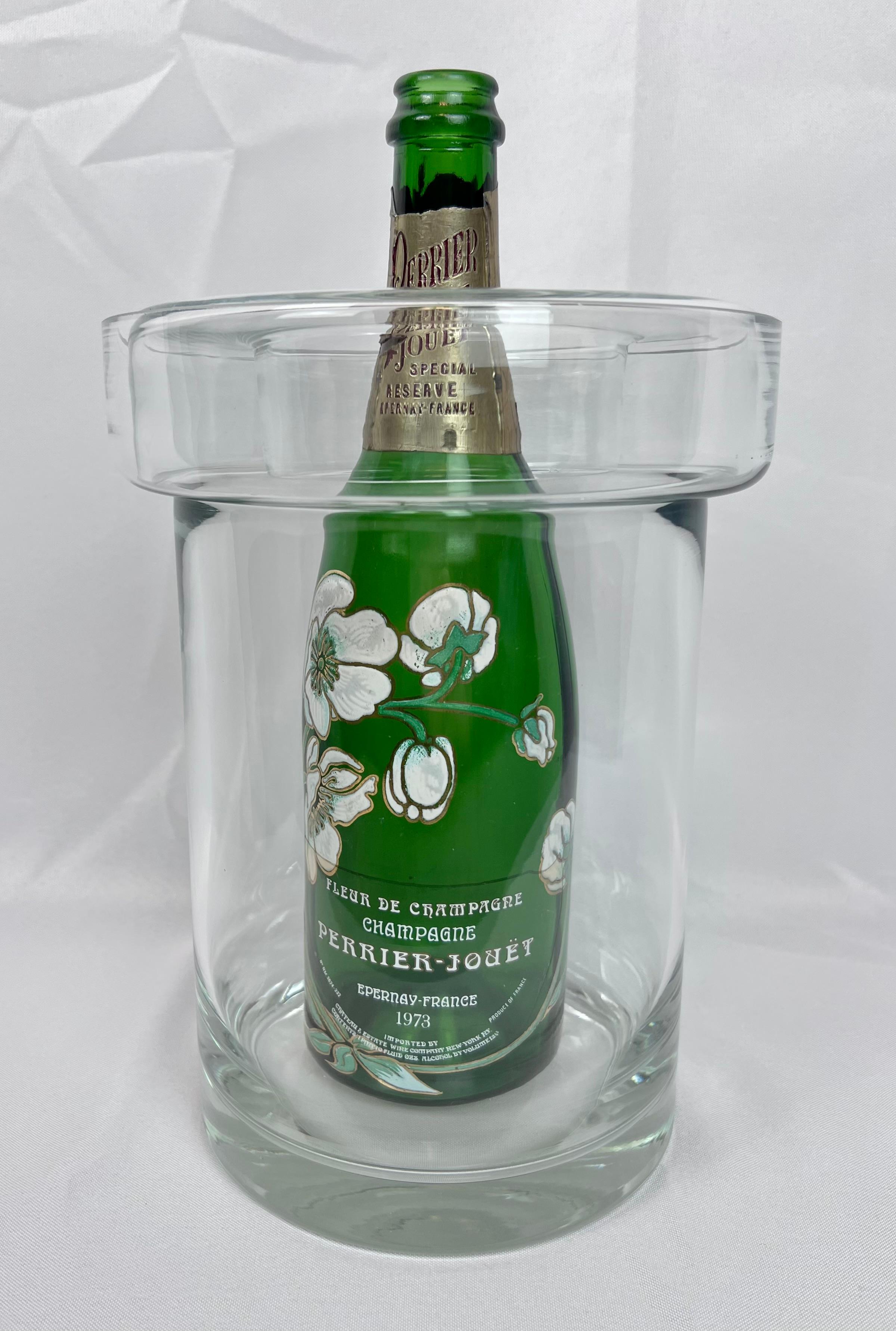 A  unique vintage blown clear glass champagne/wine cooler with a removable collar.  Originally merchandised by Colony Glass Company (now defunct) and hand made in Europe.  The edges are polished and the base is 3/4” thick.  The collar can be removed
