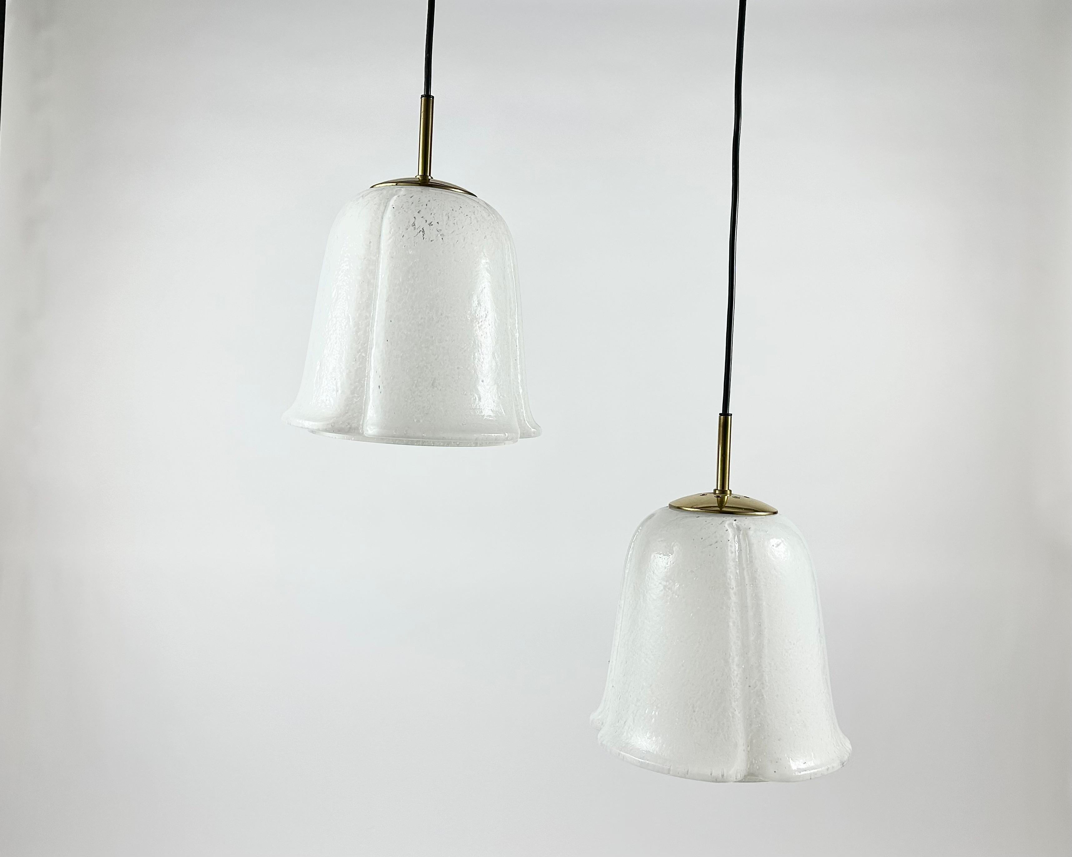 Beautiful early Italian glass pendant lights from the 1970ss. Constructed out of glass with stunning gilt brass fixtures.

Attractive glass vintage lamps that can be used as an accent in the interior and looks great on the ceiling.  

Time to invest