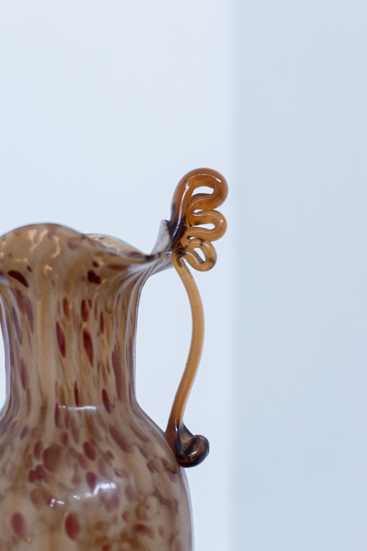 Wunderschöne Vase aus Murano-Glas, entworfen von Fratelli Toso in den 1920er Jahren. 
Das geblasene Glas ist bernsteinfarben mit dunkelroten Nuancen, eine besondere Kunstfertigkeit des Murano-Glases.
Die Vase hat weiche und geschwungene Formen,