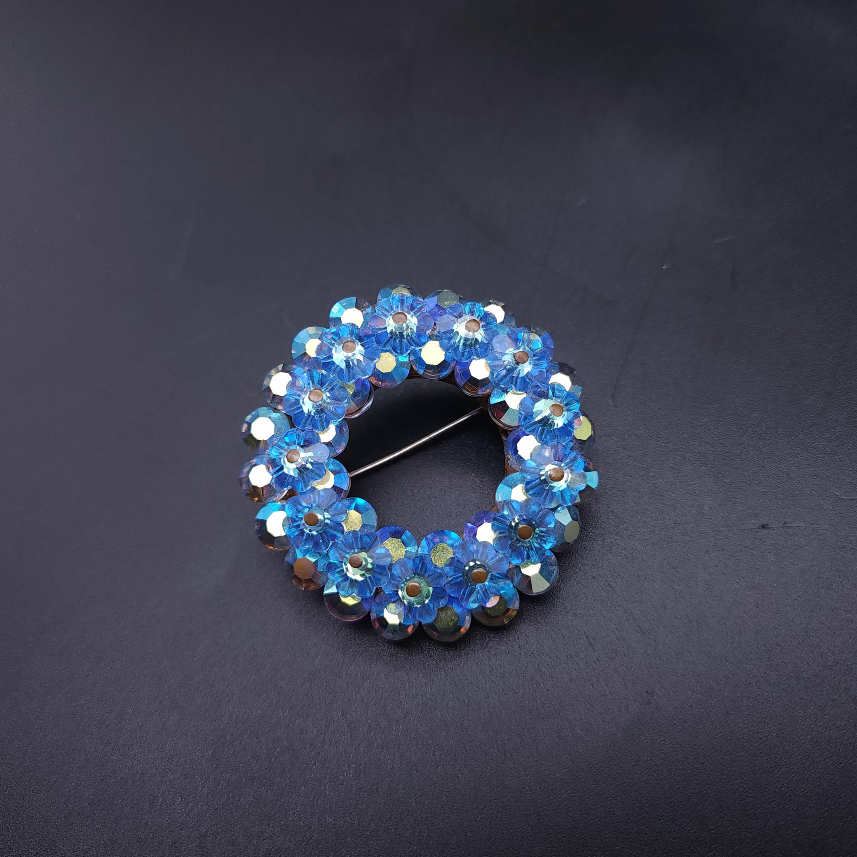 Brooch size: 1.75 inches
Earring size: 0.75 inches each

Indulge in the timeless elegance of our vintage blue crystal demi parure, featuring a mesmerizing brooch and matching clip-on earrings. Each piece is meticulously crafted with a radiant light