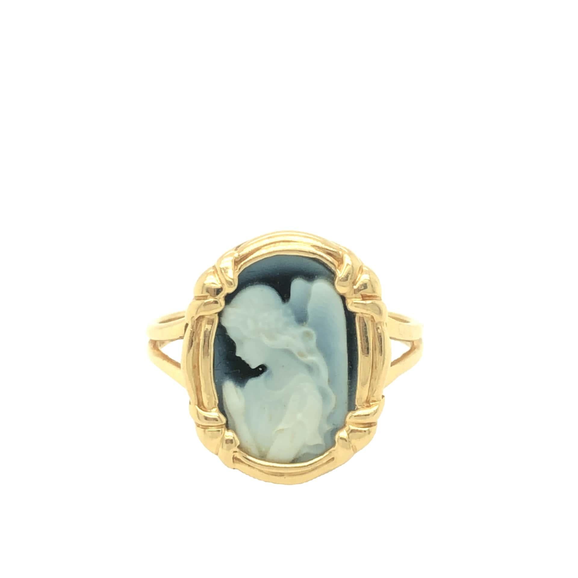 This sweet praying angel is beautifully carved on blue agate and adorned in ribbon motif 14K yellow gold frame. The ring is in pristine condition and stamped OTC 14K.

Gross weight 2.9 grams. Size 7 (resizable)