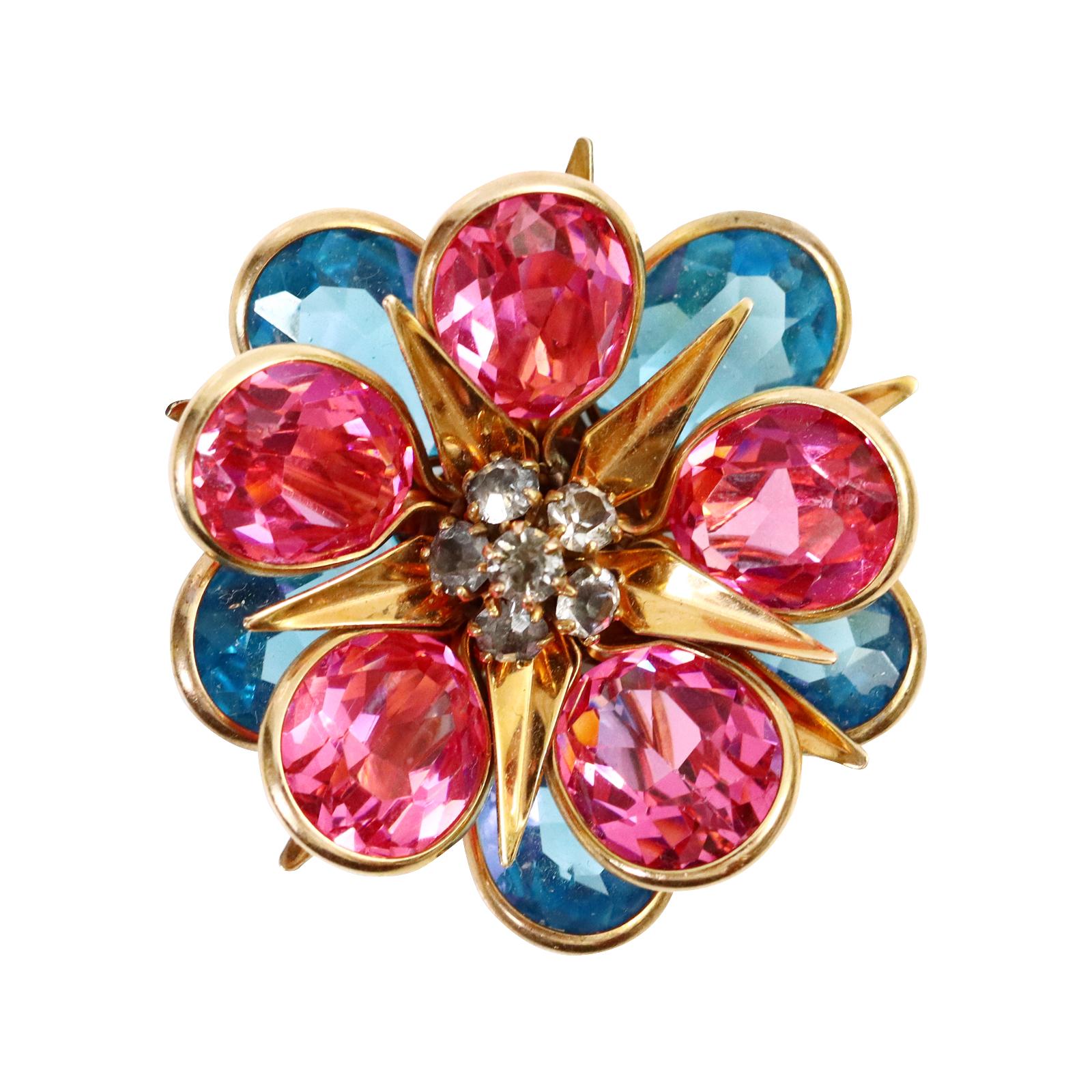 Vintage Blue and Pink Crystal with Grey Stones Brooch Circa 1940s.  This is a very interesting and very well made brooch.  The petals are stacked on top of two tiers of a rose gold color star shaped support.  One layer is blue. The next is pink. 