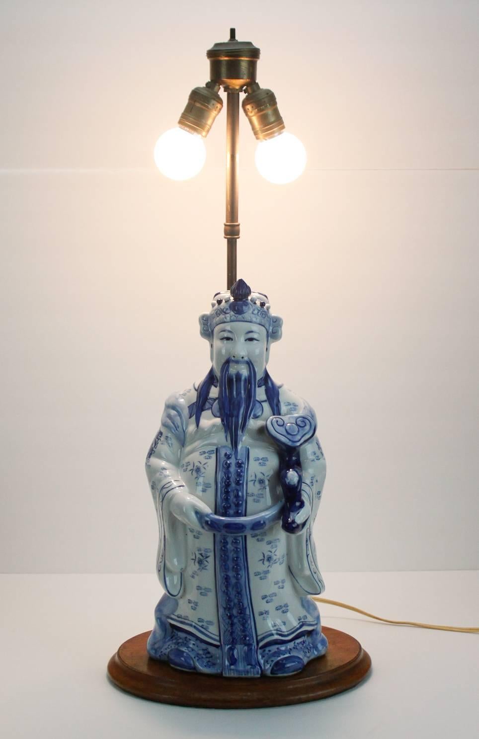 Vintage blue and white ceramic Chinese figural lamp. Lamp takes two light bulbs. In excellent vintage condition. Measures: Figure stands 16