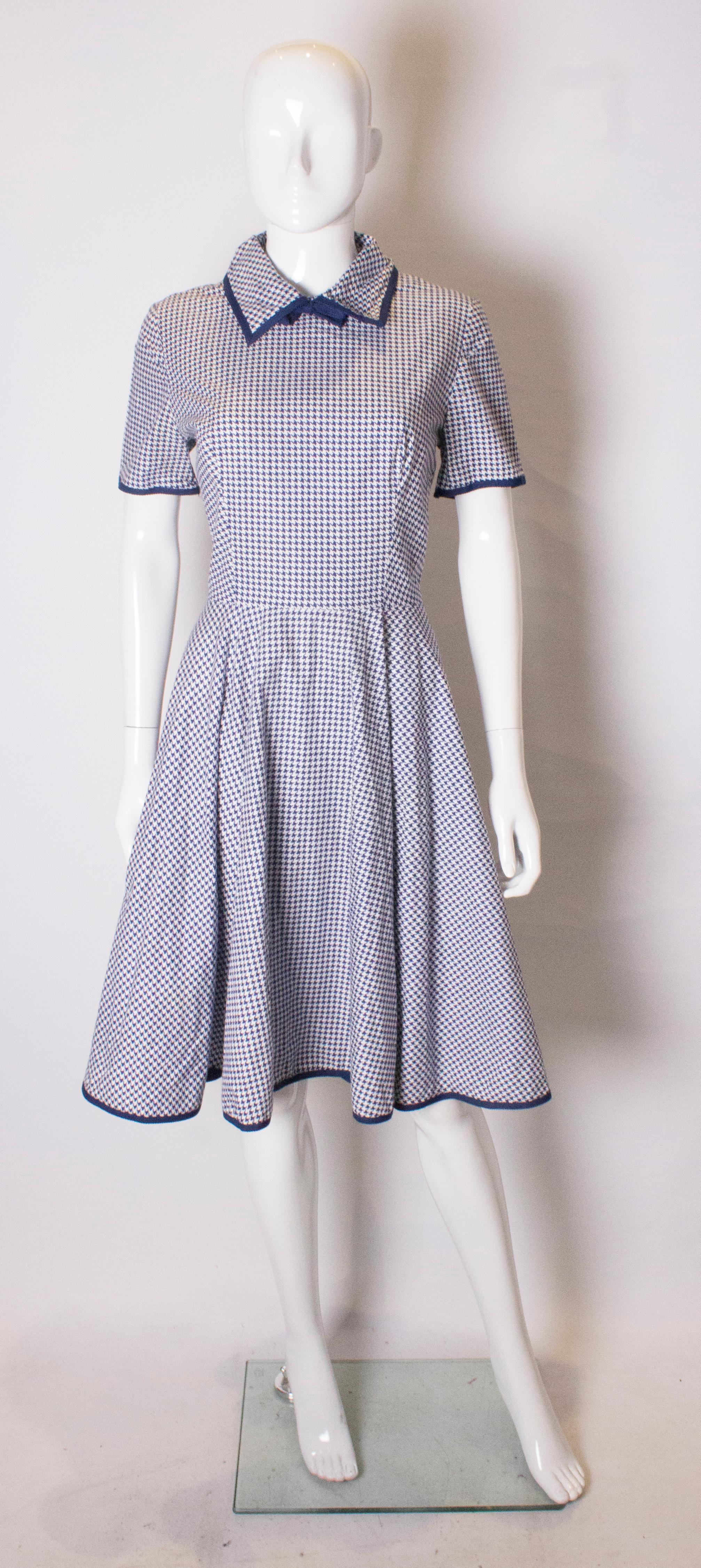 
A vintage 'California '  blue and white cotton dress. It has a small collar, central back zip and a full skirt.