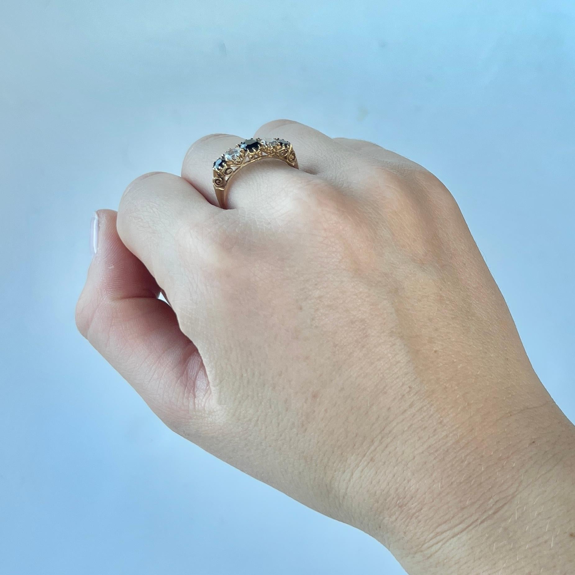 This gorgeous ring holds three deep blue paste stones. The central blue stone measures 40pts and the outer sapphires measure 15pts each. The white stones between these blue stones measure 25pts each. Modelled in 9carat gold. 

Ring Size: P or 7 1/2
