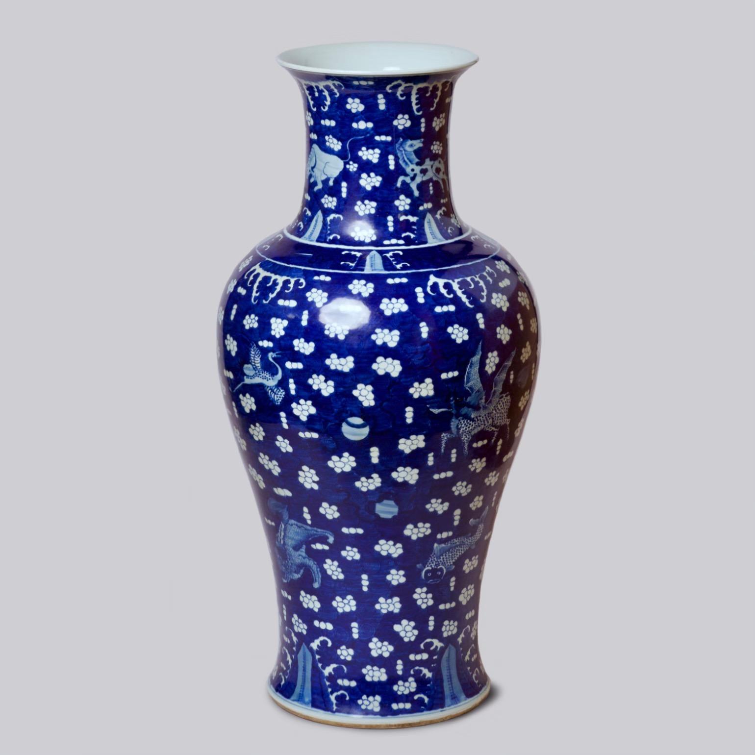 This vase is a traditional porcelain vessel from Jingdezhen, a town long distinguished by imperial patronage. An uncommon blue field with clouds and auspicious creatures set this vase apart from the blue and white we most commonly see. The names of