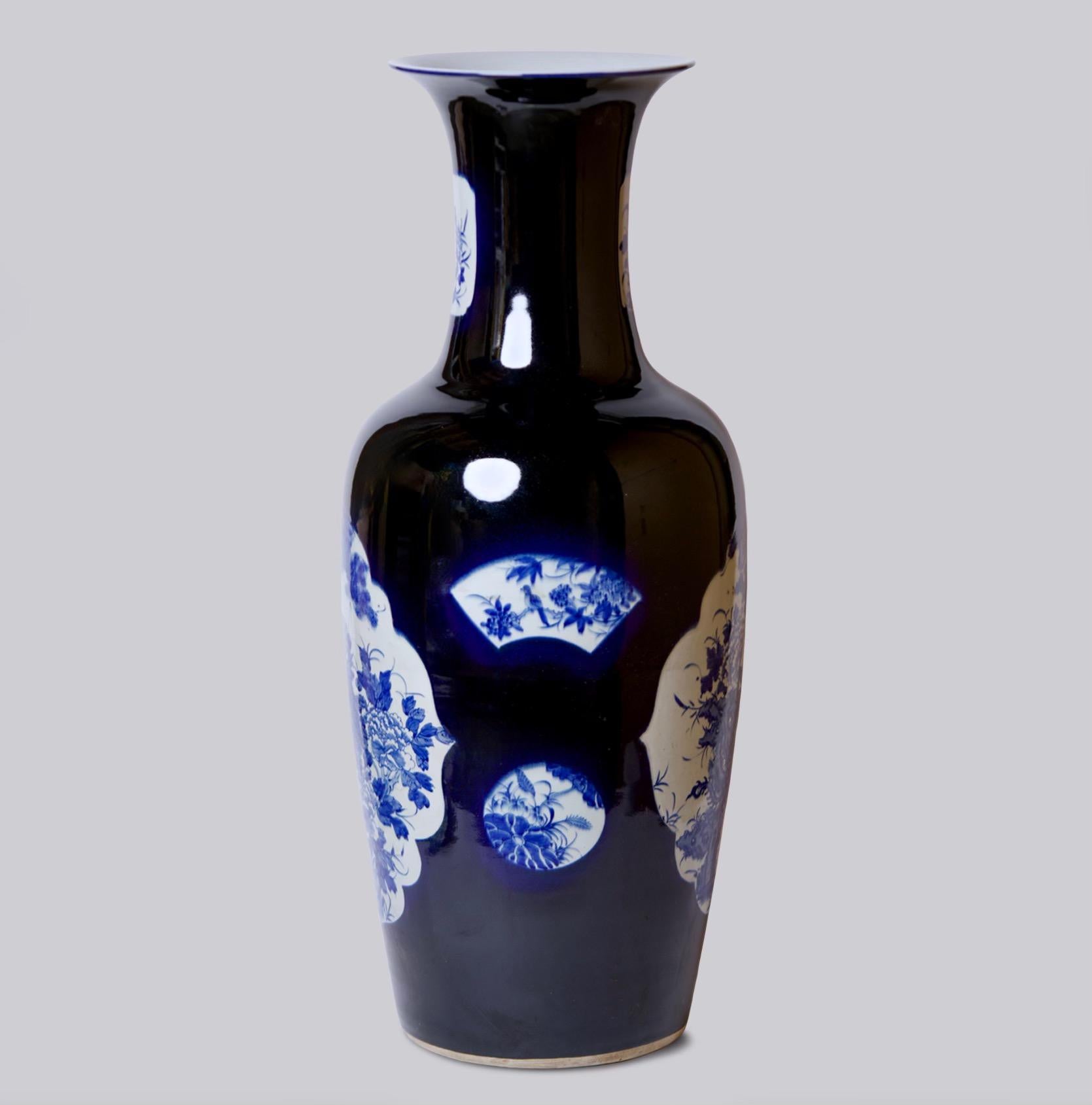 This vase is a traditional porcelain vessel from Jingdezhen, a town long distinguished by imperial patronage. An uncommon blue field and floral panels set this vase apart from the blue and white we most commonly see. The lively floral still life