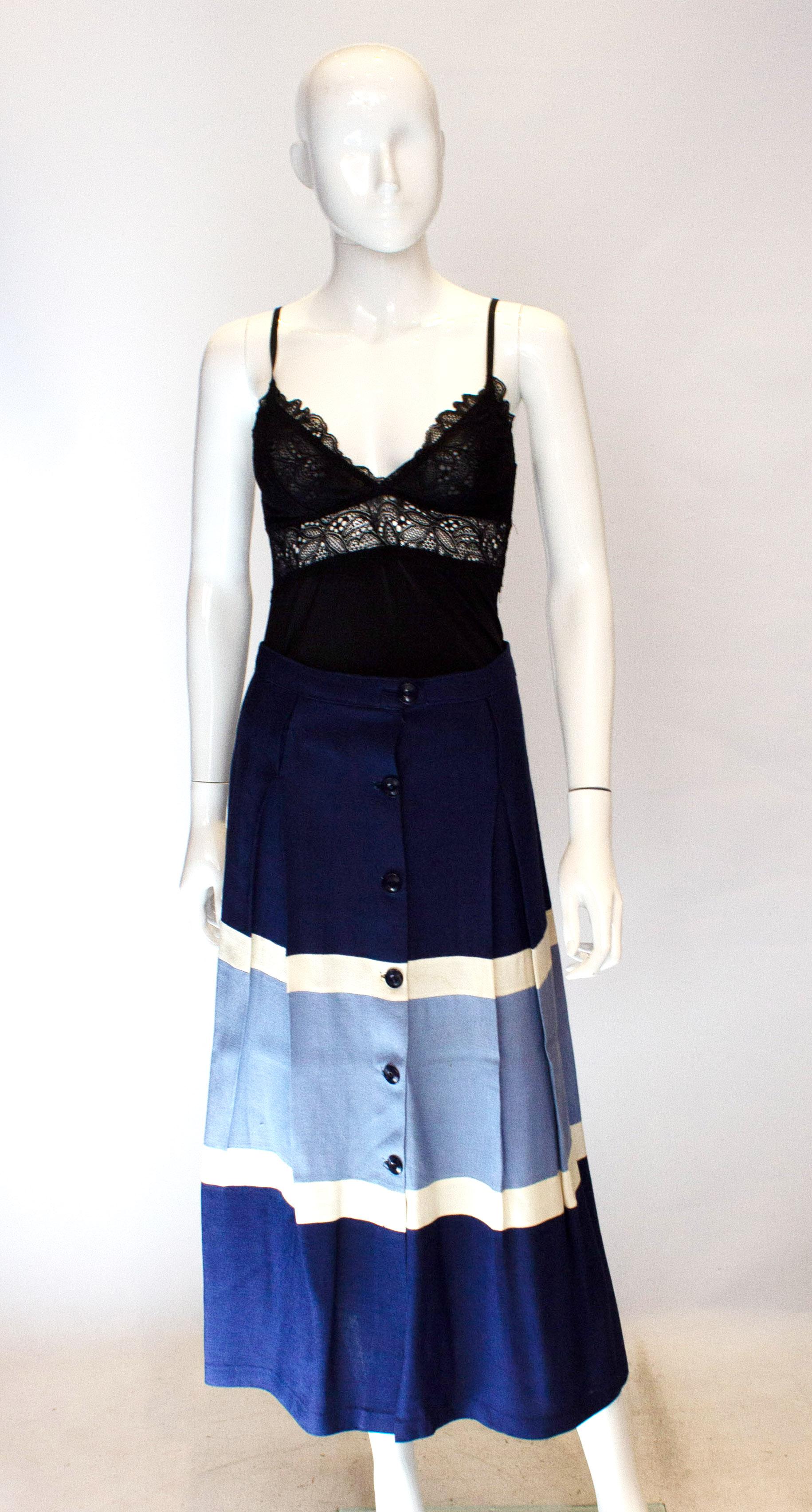 A fun vintage skirt for Summer. The skirt is in blue and white horizontal bands of colour. It has pleats that start below the waistband and so produce a flattering line. The skirt is unlined, and has a side button opening.
Marked size 44, waist