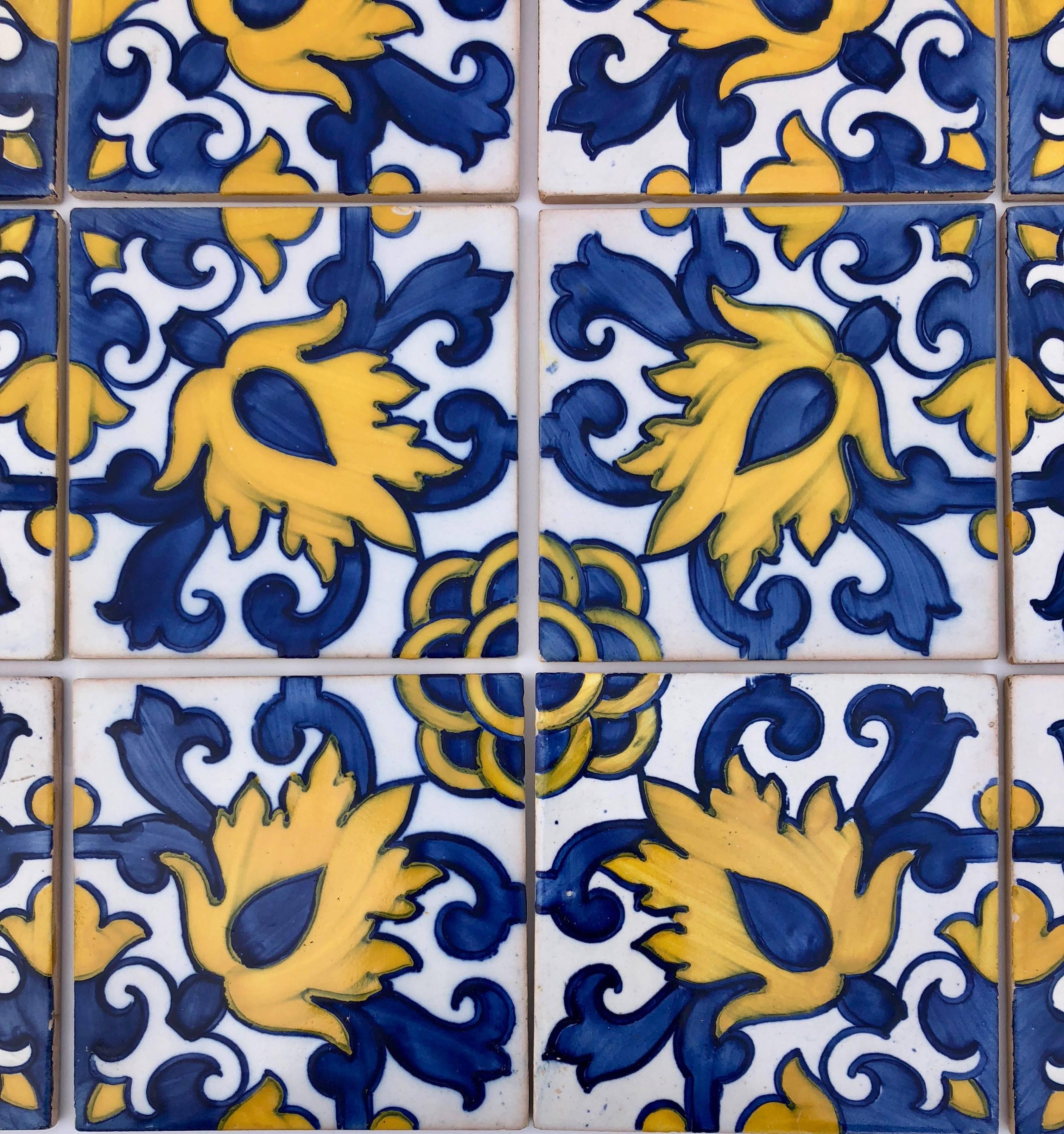 These tiles are beautiful with vibrant blues and yellows on a white background in a lovely design. They could be used to add a touch of color to a bathroom or kitchen all or as coasters or trivets on a table, the possibilities are endless.
 