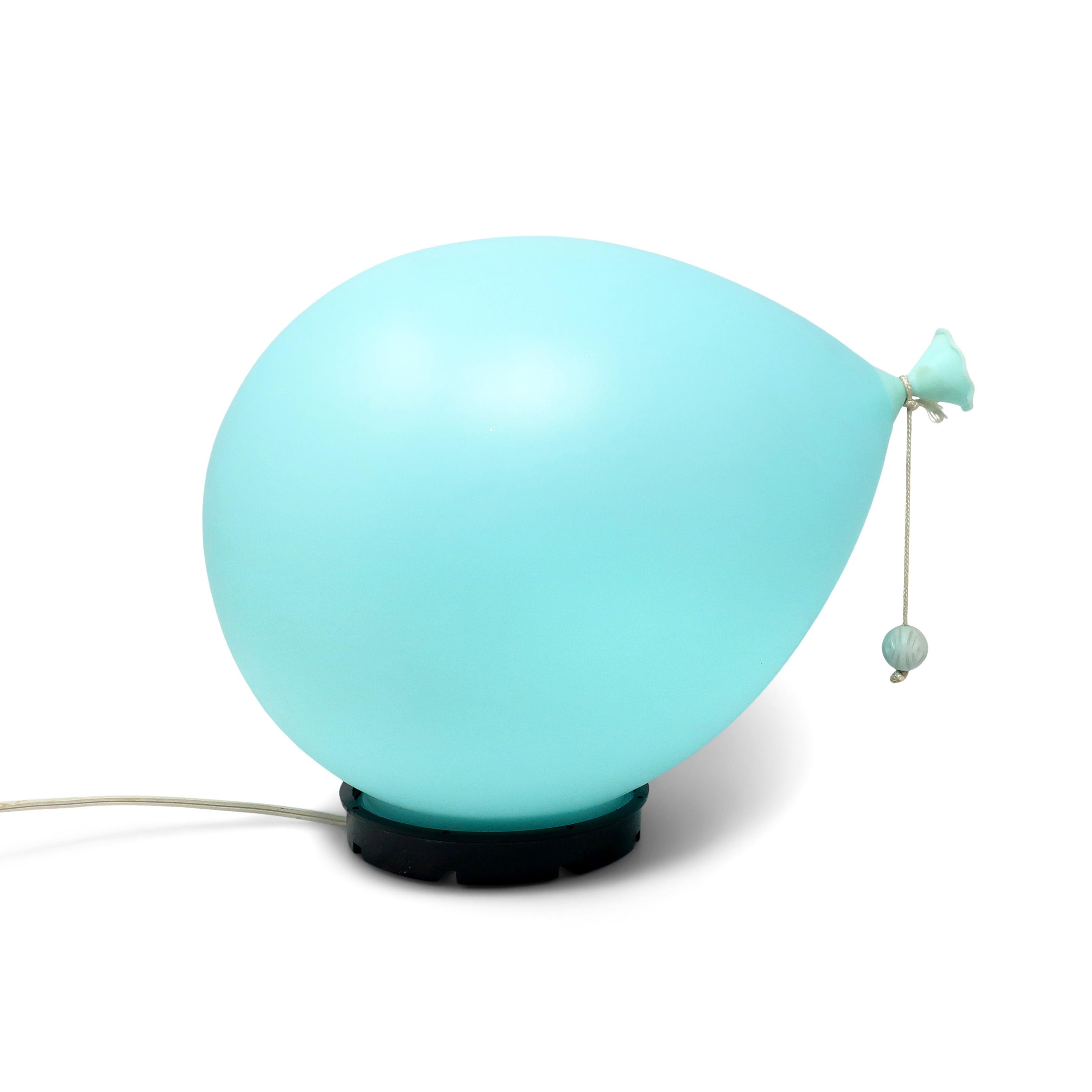 An iconic Italian balloon lamp designed by Yves Christin in 1975.  This is the middle of the three sizes and has a soft blue colored balloon, black base, and textured bead at the end of the string

In very good vintage condition with on/off switch