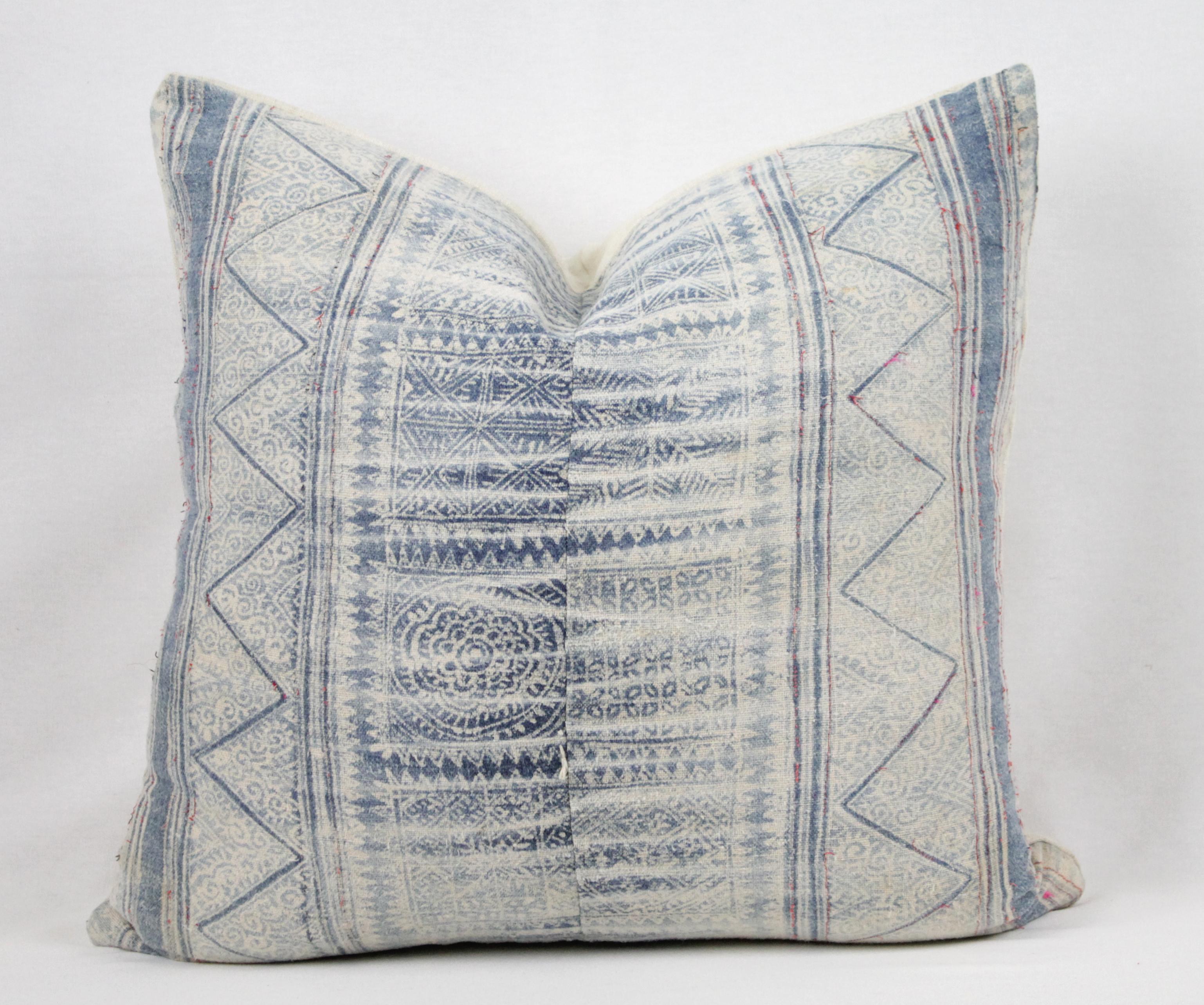 Vintage blue batik style pillow with zipper closure. Back is in antique French linen. Main colors are off-white with a medium blue, light blue color, with red thread running through the design. Does not include insert. Measures: 20