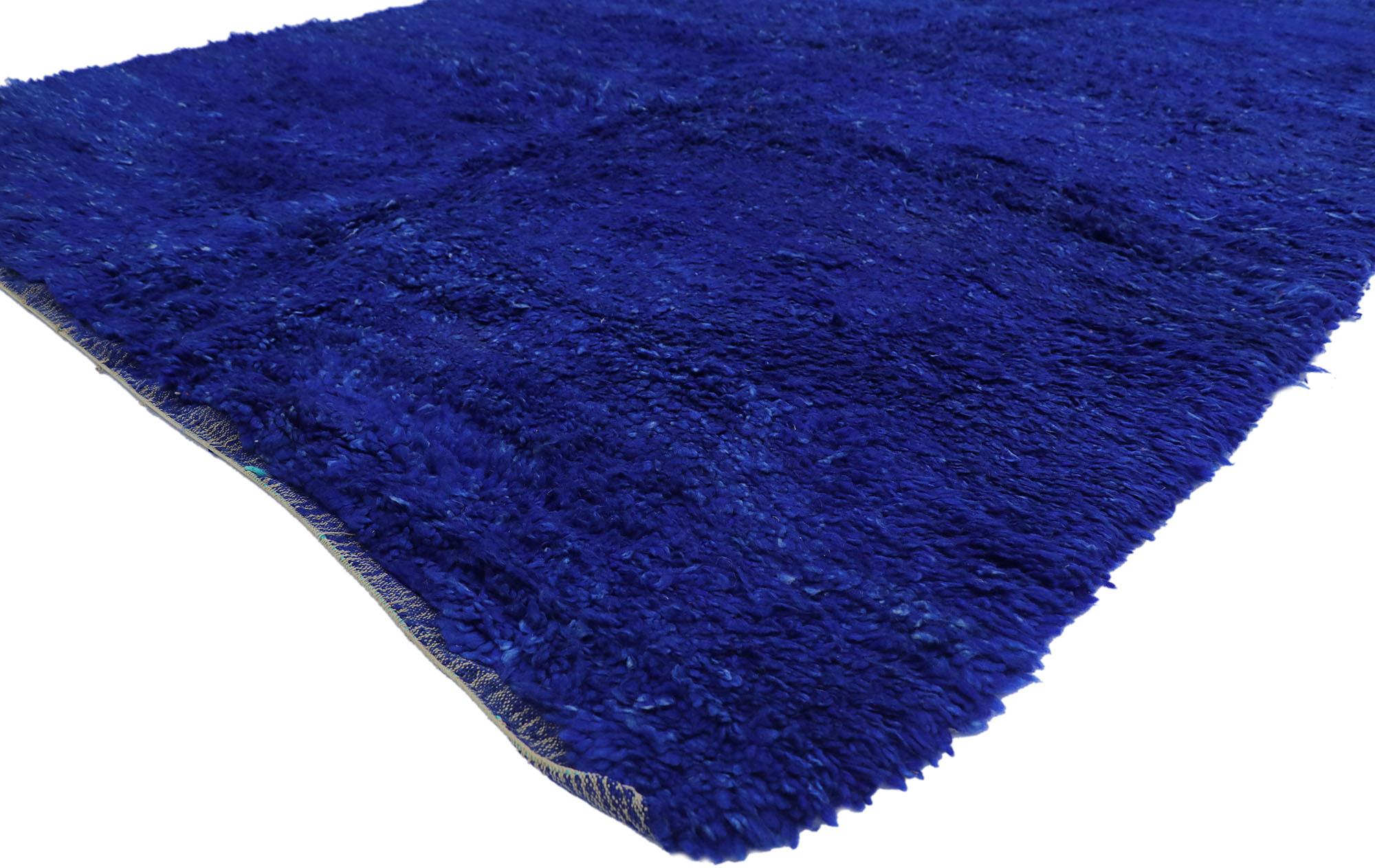 Cozy nomad meets mesmerizing Marjorelle Blue in this hand knotted wool vintage Beni MGuild Moroccan rug. Get ready to be transported to a peaceful and captivating place with this vintage Moroccan rug appearing as your magic carpet ride. Imagine a