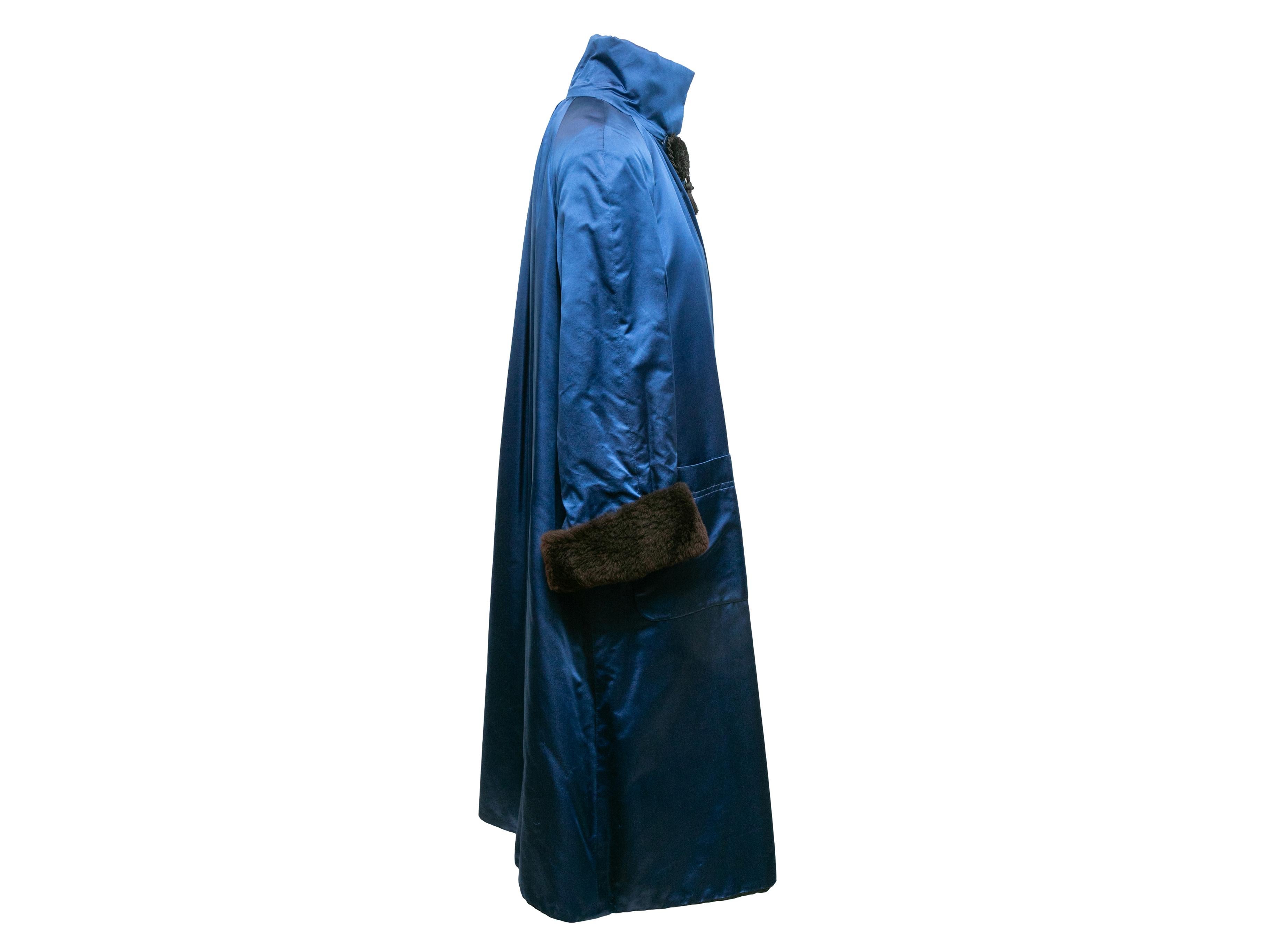 Vintage blue silk and brown faux fur coat by Valentino Boutique. Stand collar. Dual patch pockets at hips. Front closure. 30