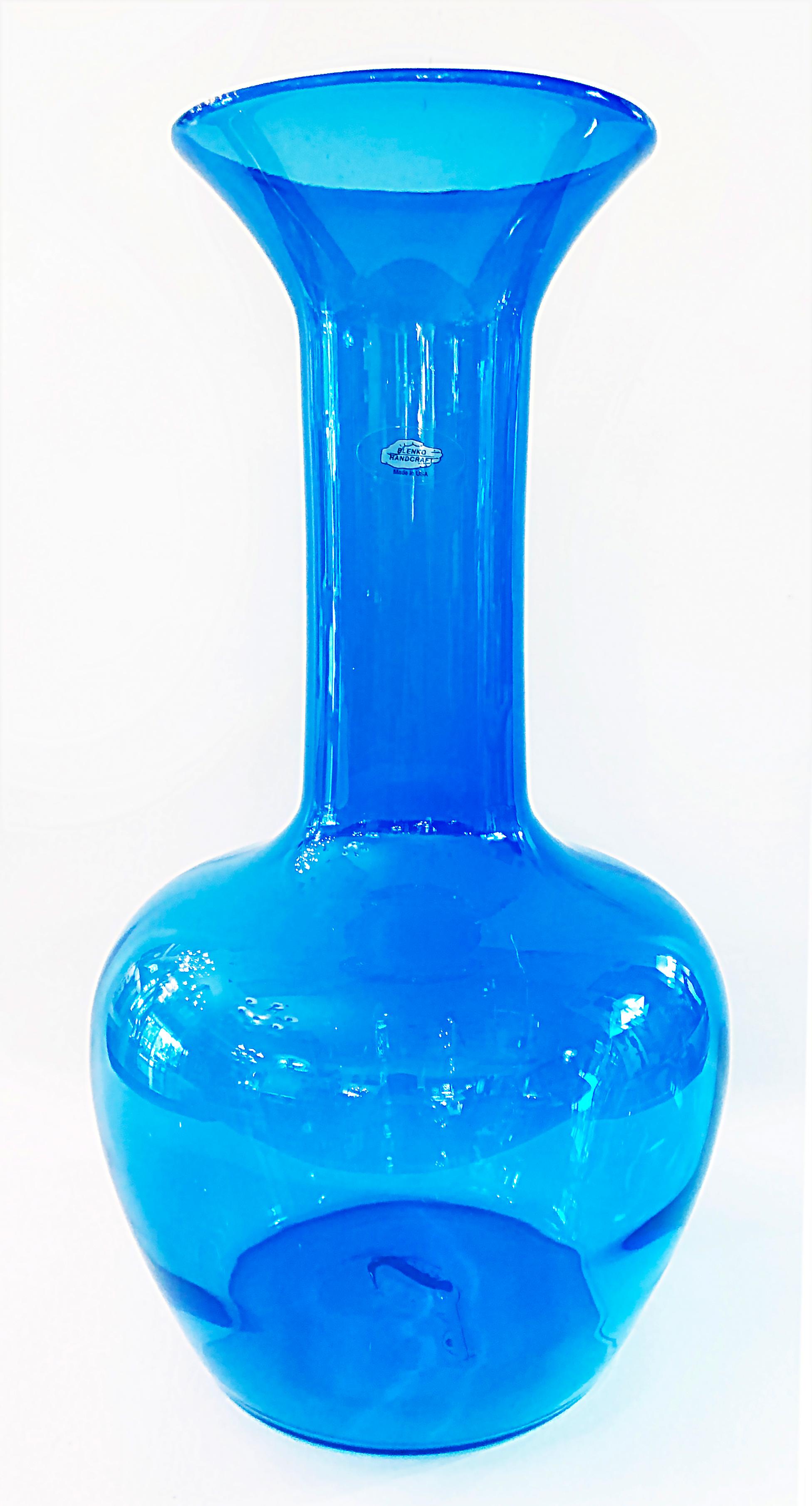 Vintage blue Bulbous Blenko blown glass vase with sticker

Offered for sale is a blue bulbous Blenko glass vase with a long neck and a flared lip. The glass vase retains the original Blenko sticker on the side of the neck which reads: 