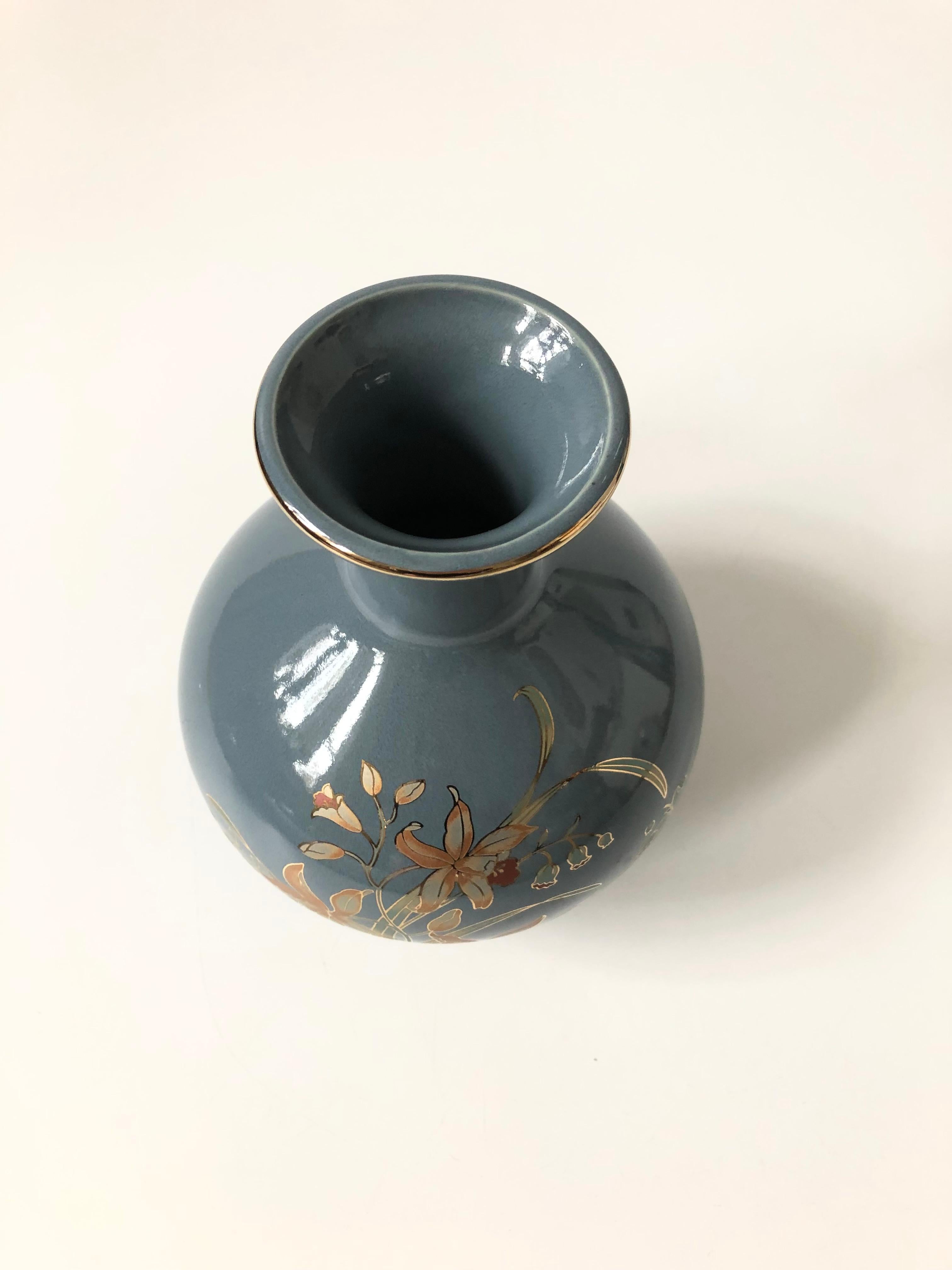 A lovely vintage ceramic vase. Glossy blue finish with a highly detailed botanic design in gold. Made in Japan.
 