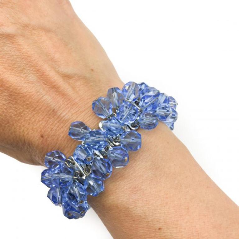 Such a fun piece. A 1950s Blue Vintage Cha Cha Bracelet. Featuring rhodium plated silver tone metal adorned with blue crystal dangling beads. Such a wonderful shade of blue! The movement in this piece makes it a very lively piece to wear. Due to the