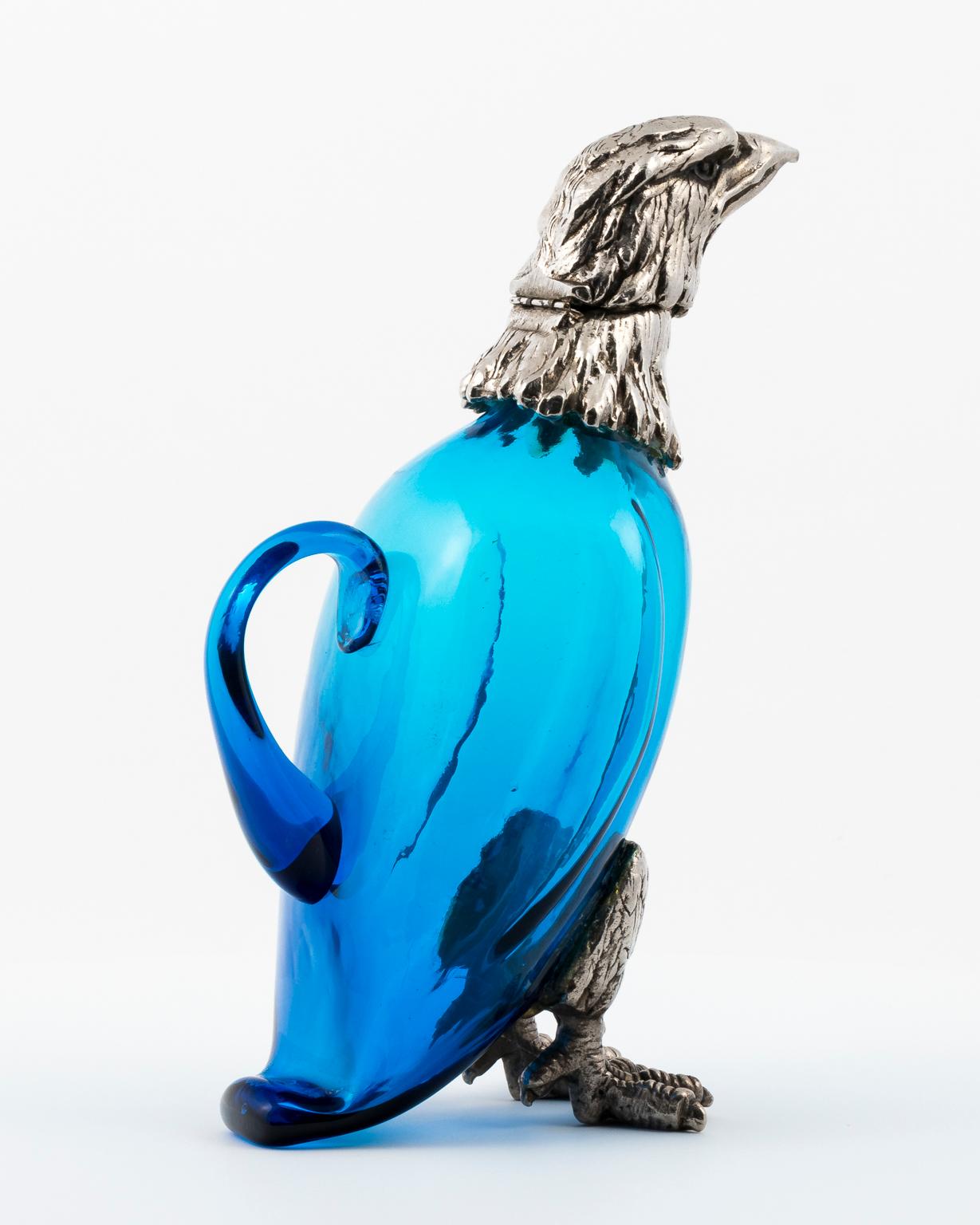 Vintage eagle decanter-blue crystal body-silver plated head and feet-head tilts back.
    