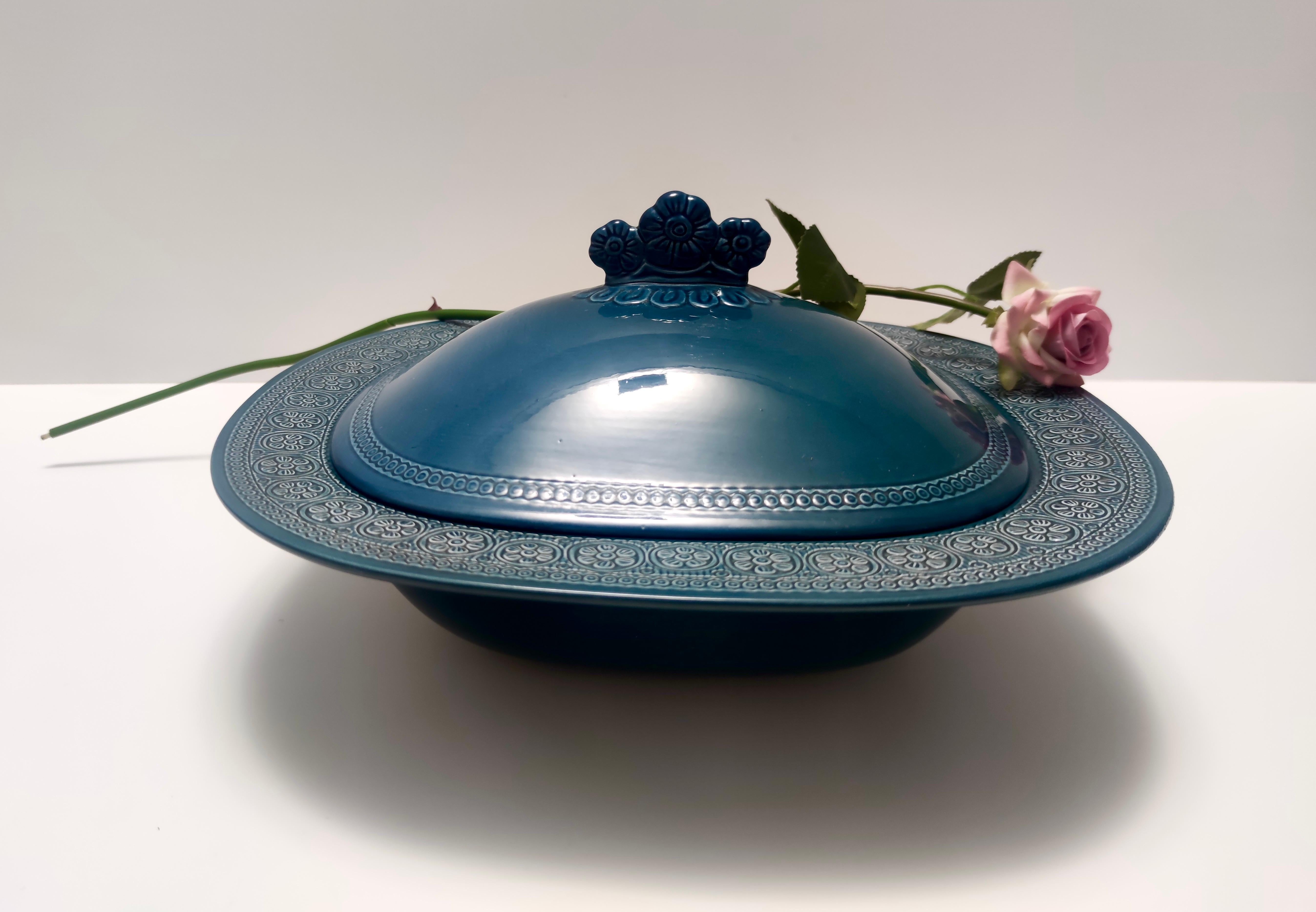 Made in Italy in 1965 by Antonia Campi for Laveno. It is marked on the bottom. 
This centerpiece bowl is made in blue lacquered earthenware with bossed decorations.
This is a vintage item, therefore it might show slight traces of use, but it can be