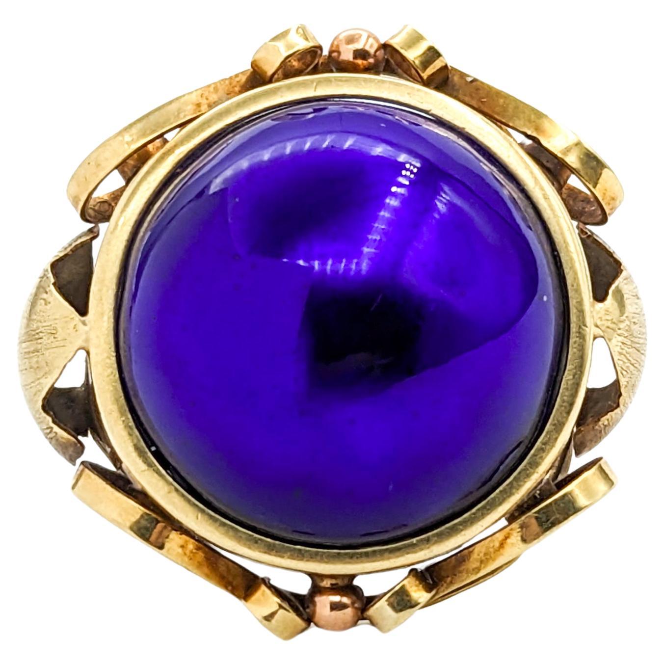 Vintage Blue Enameled Dome Ring In Yellow Gold

Introducing this exquisite Vintage Enamel Ring, a true embodiment of Mid-Century elegance, crafted in rich 14k yellow gold. This unique piece features a striking cobalt blue enameled dome centerpiece,