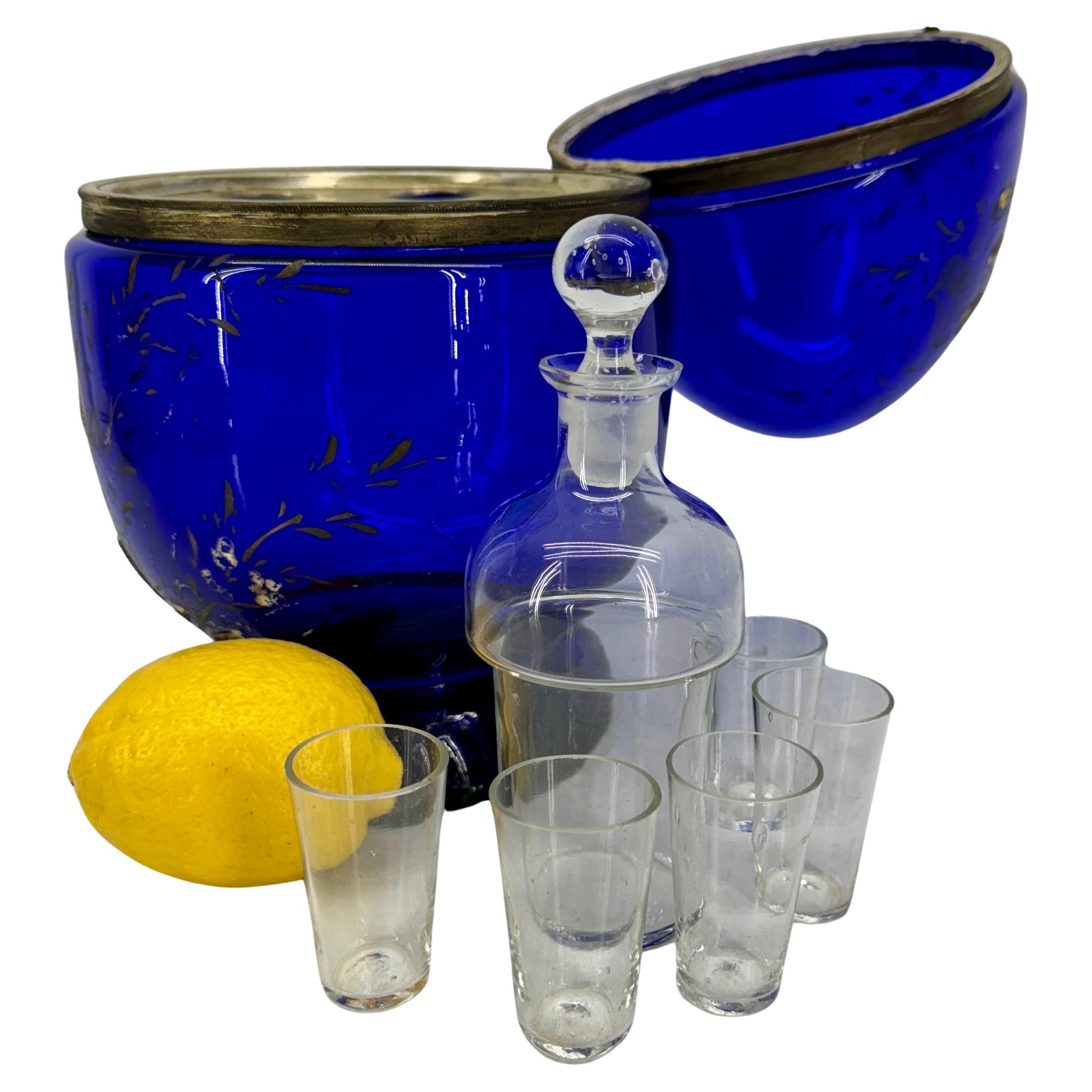 Blue Glass Art Hinged Egg Domed Liquor Decanter 

Striking cobolt blue decanter with shot glasses. A great statement piece to elevate your bar cart. 