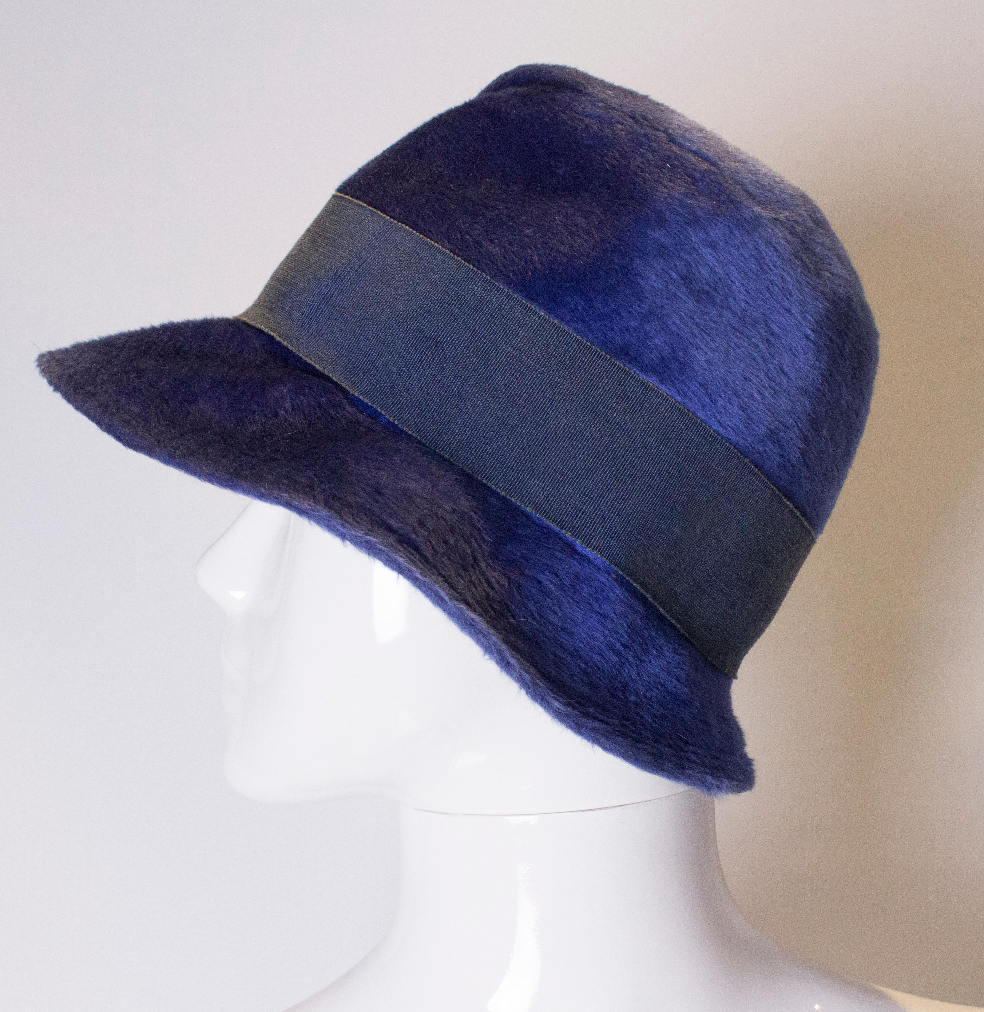 A head turning hat in a wonderful royal blue colour. The hat has an interesting fold detail , and ribbon trim. Height 7''