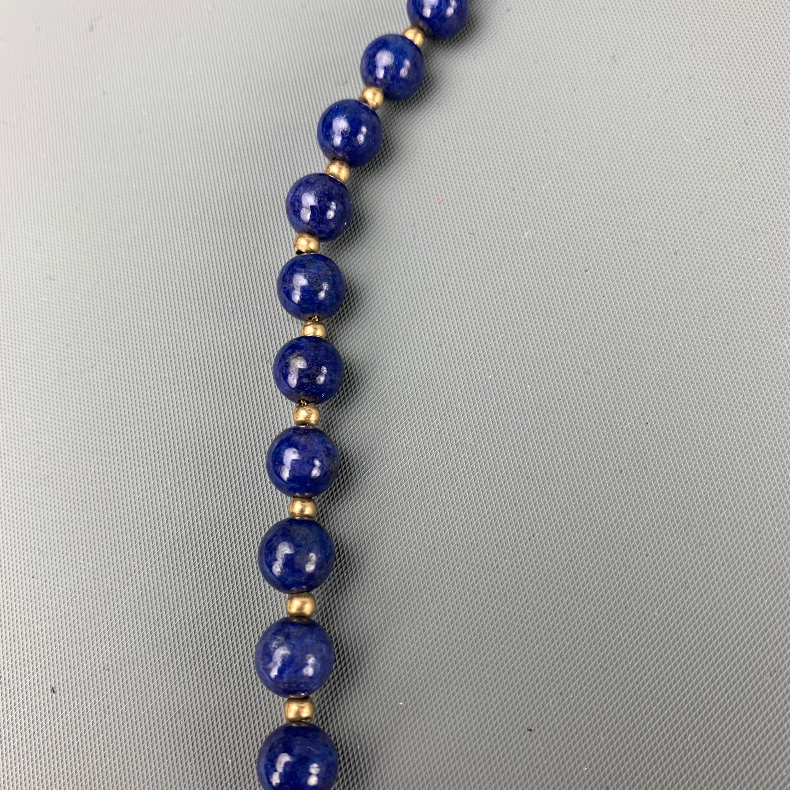 VINTAGE necklace comes in a blue lapis lazuli beaded design featuring a 14 K chain and a clasp closure. 

Very Good Pre-Owned Condition.

Measurements:

Length: 24 in. 