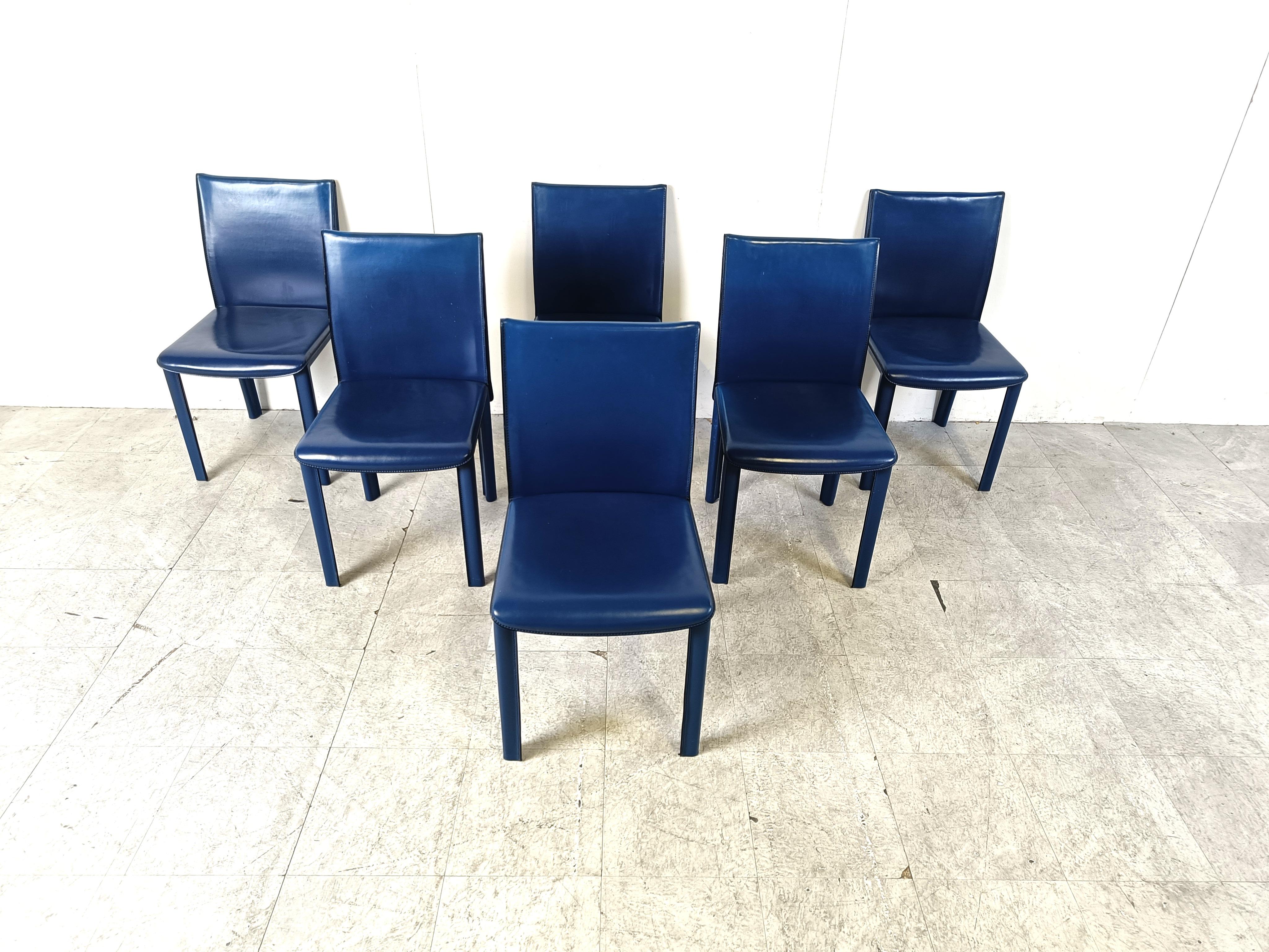 Vintage vibrant blue leather dining chairs by Arper Italy.

High quality and sturdy stiched leather dining chairs with a timeless design. 

A nice detail to mention is the cross stitching at the back of the backrests.

Good