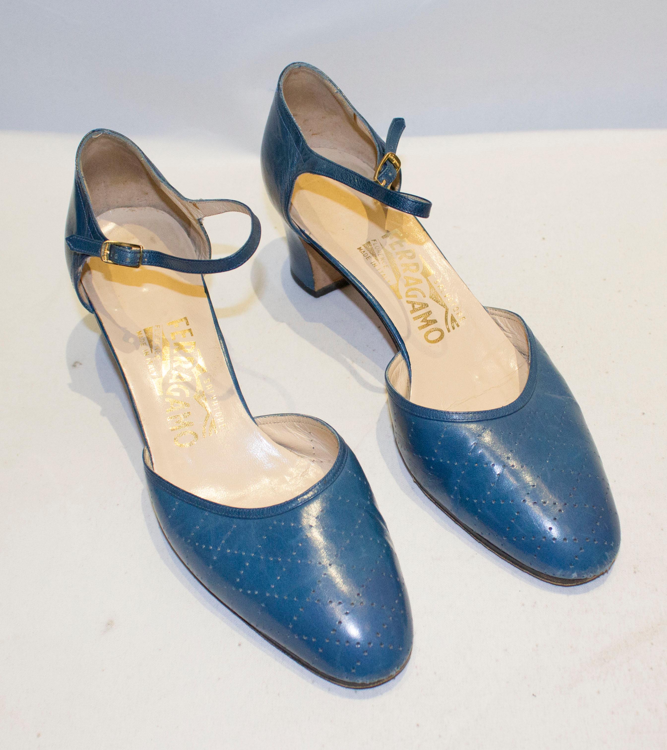 A fun pair of shoes by Salvatore Ferragamo. In blue leather the shoes have punched detail on the front and an ankle strap The heel is 2 1/2''.