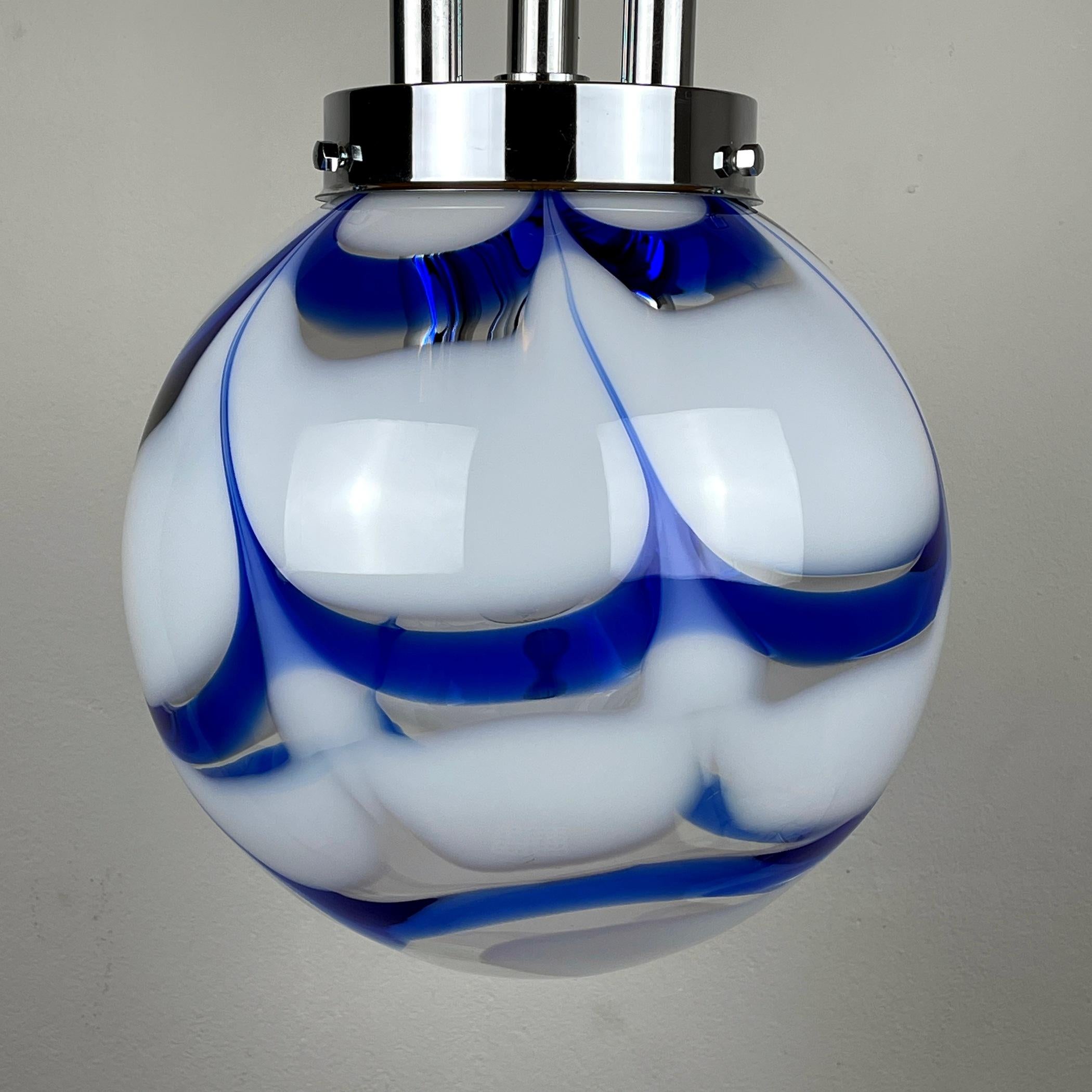 This large, beautiful vintage blue-white Murano lamp by Mazzega was made in Italy in the 70s. Perfect vintage condition. No chips or cracks. The metal has a patina. Requires 3 standard Edison E14 with a screw lamp and one E27. Mid-century swirl