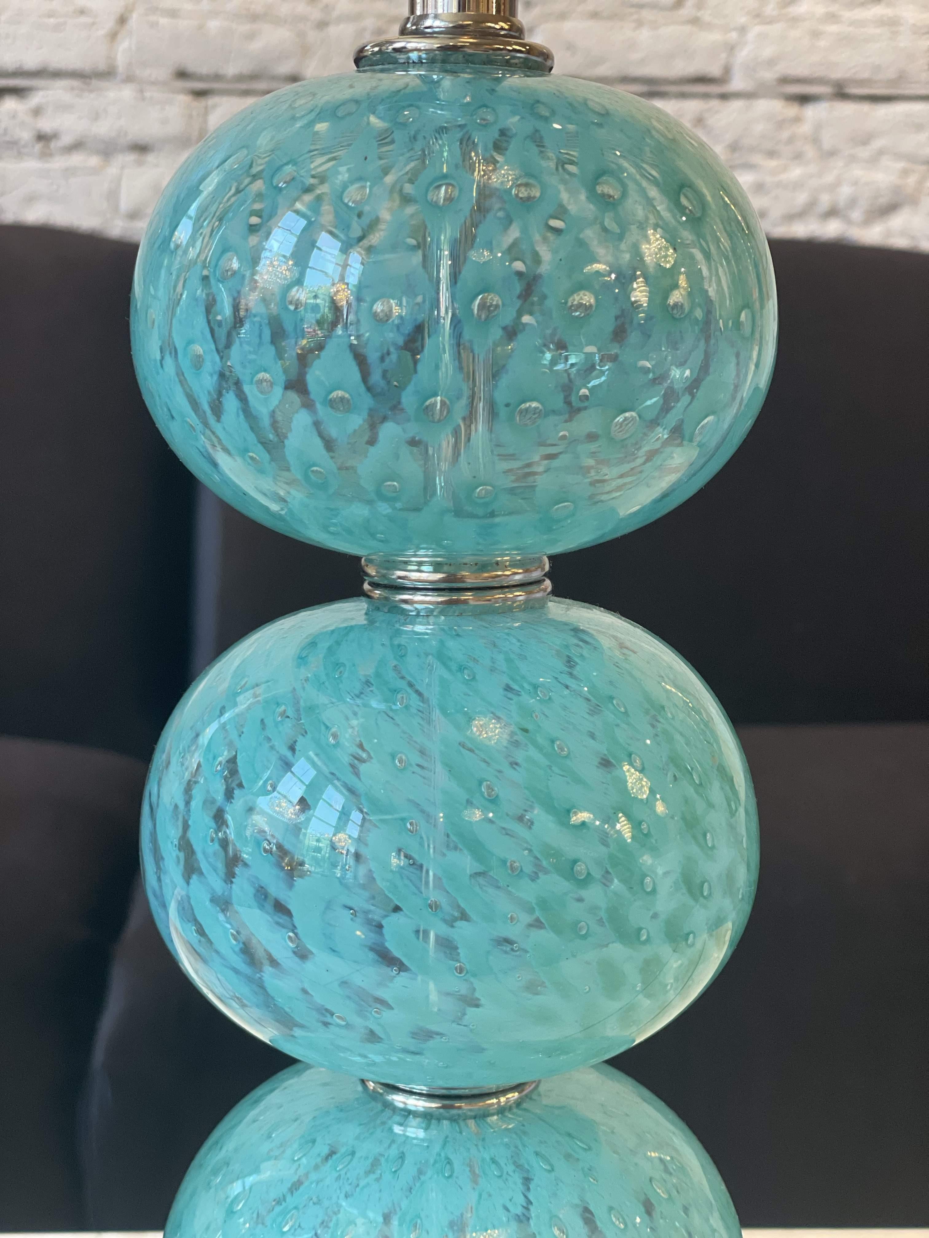 A stunning pair of vintage Murano lamps, circa 1970. Comprised of a series of blown glass balls, fabulous color and pattern introduced via reverse paint. Atop the original thick Lucite disk base. Exquisite jewelry! Excellent restored condition.
