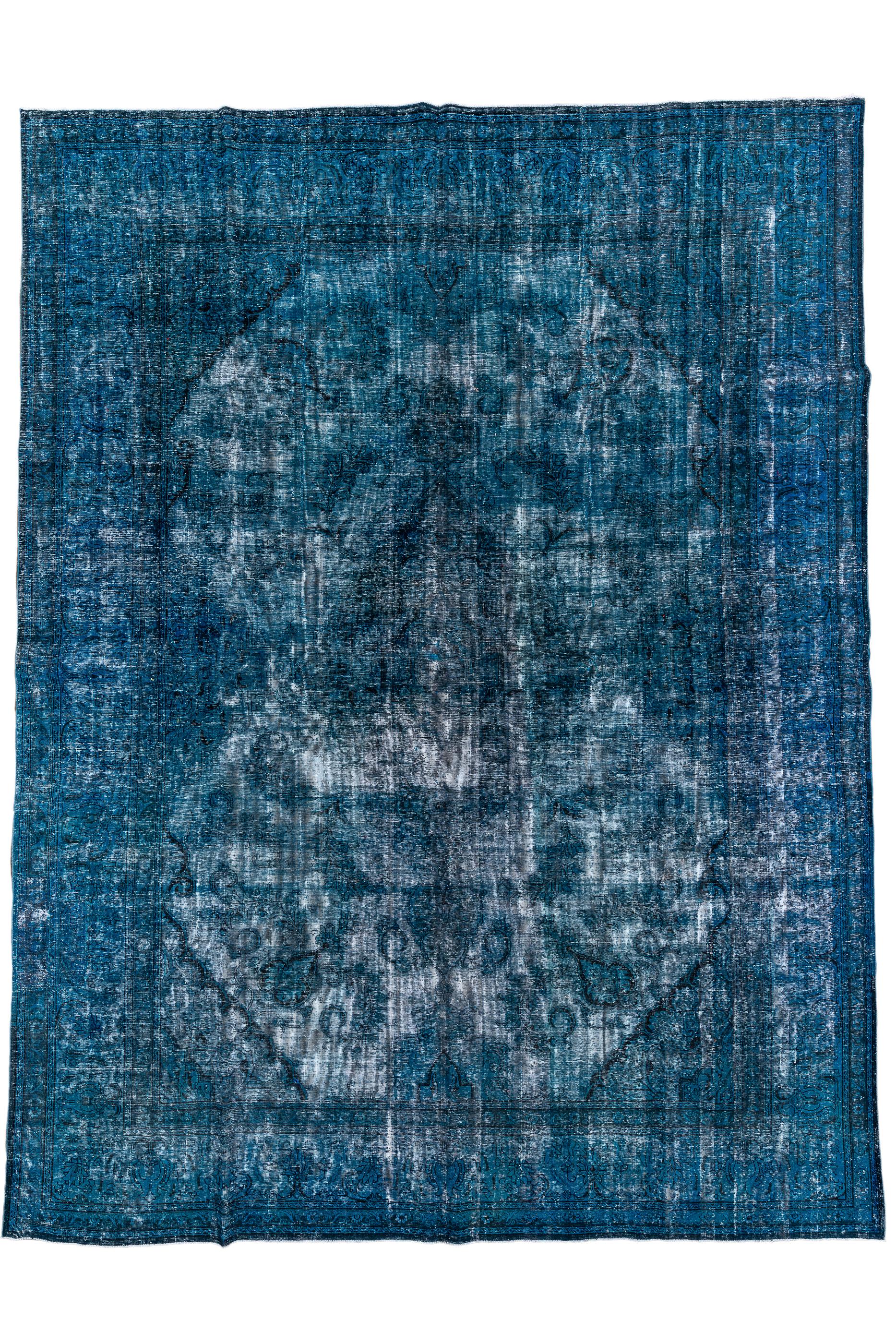 The white foundation made visible by the extreme distress show up as an additional colour besides the shades of blue and red. Intentional distress is a recent innovation. The field is basically two large octagons within a blue border.

Rug