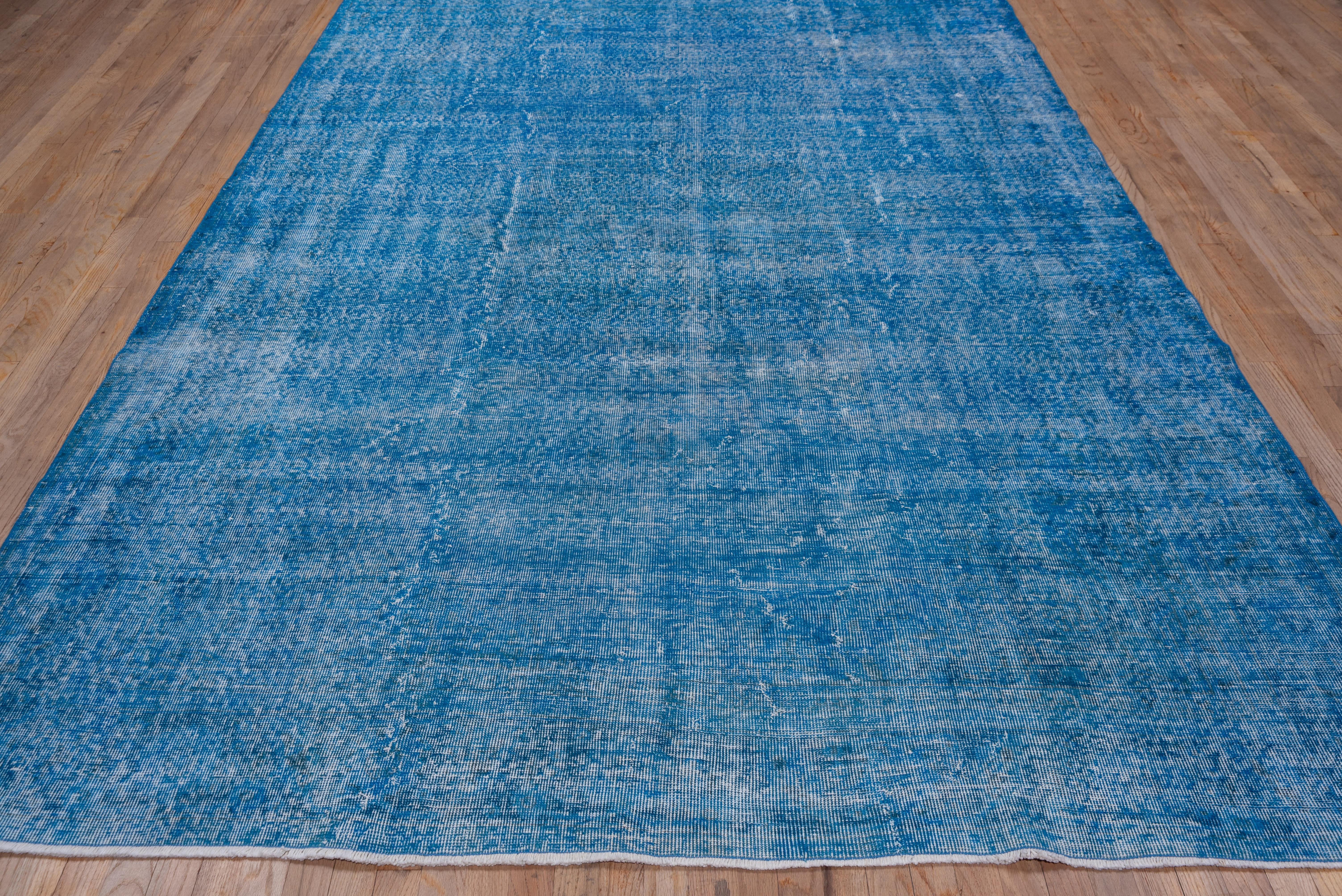 This blue Turkish overdyed Sparta carpet has a pattern defined by the wear beyond the all-over general distress. Vertical and horizontal off white strips cross near the center. Shabby chic conditions and can offer some great texture for floor