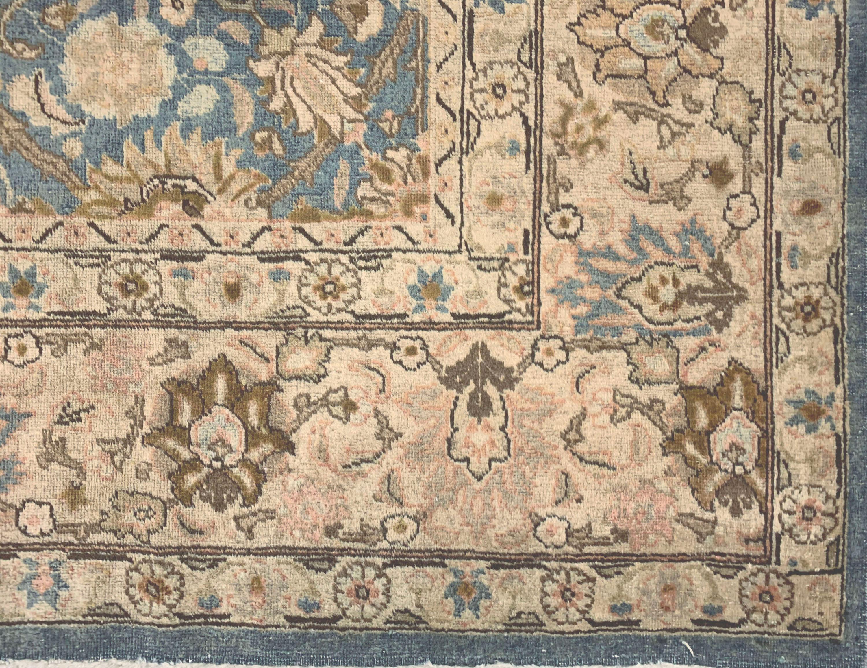 8'5 x 11'. This highly decorative Tabriz carpet from northwest Persia juxtaposes a mid-blue field (with just a touch of green) with a beige border. The all-over field pattern of palmettes is derived from 17th century Kerman “Vase” carpets and indeed