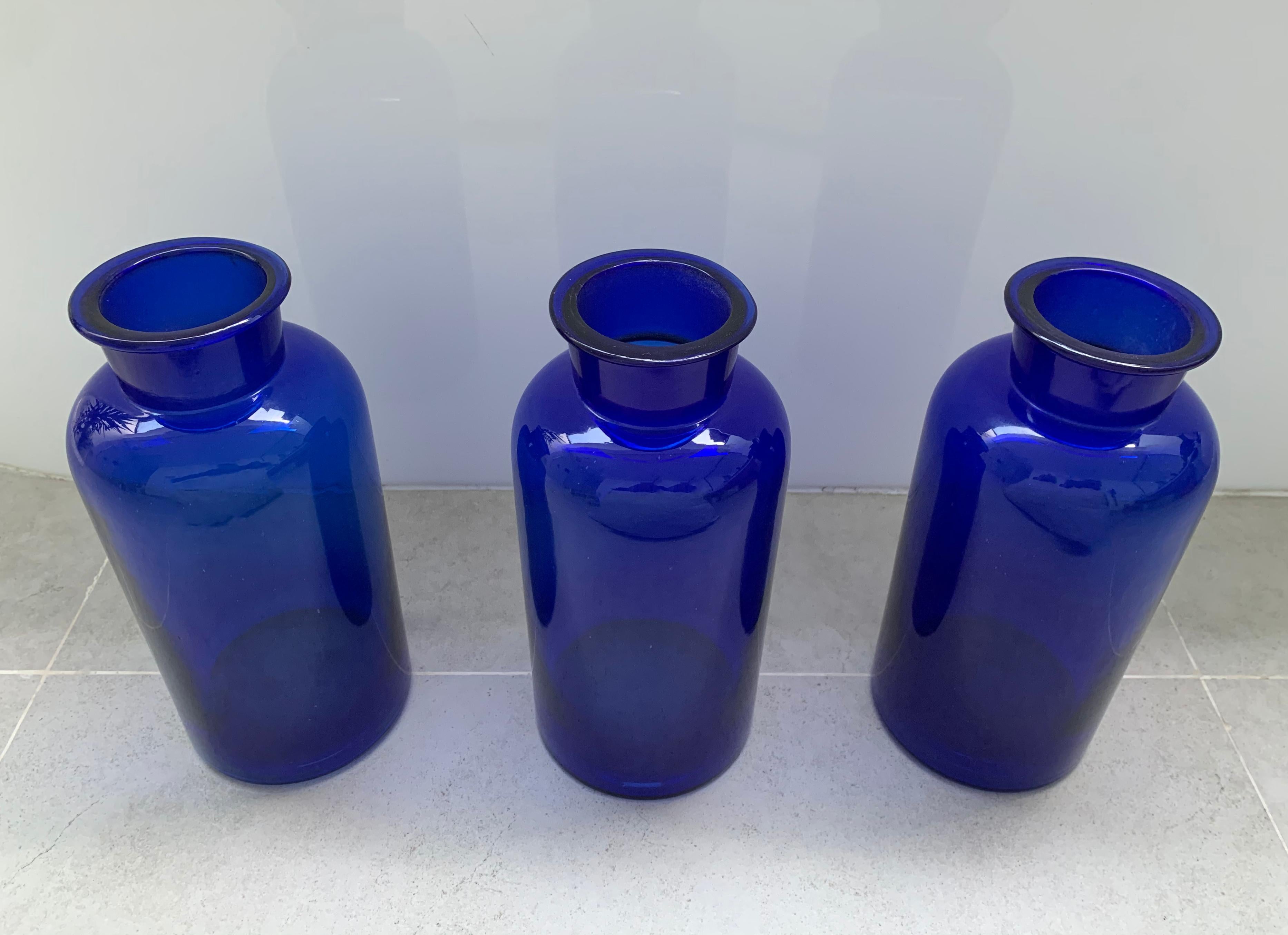 A set of vintage Dutch Cobalt blue pharmacy bottles from the early 20th century. The cobalt blue glass served as a protector of the bottles contents from sunlight. These bottles were used by pharmacies to store bulk quantities of medicinal powders,