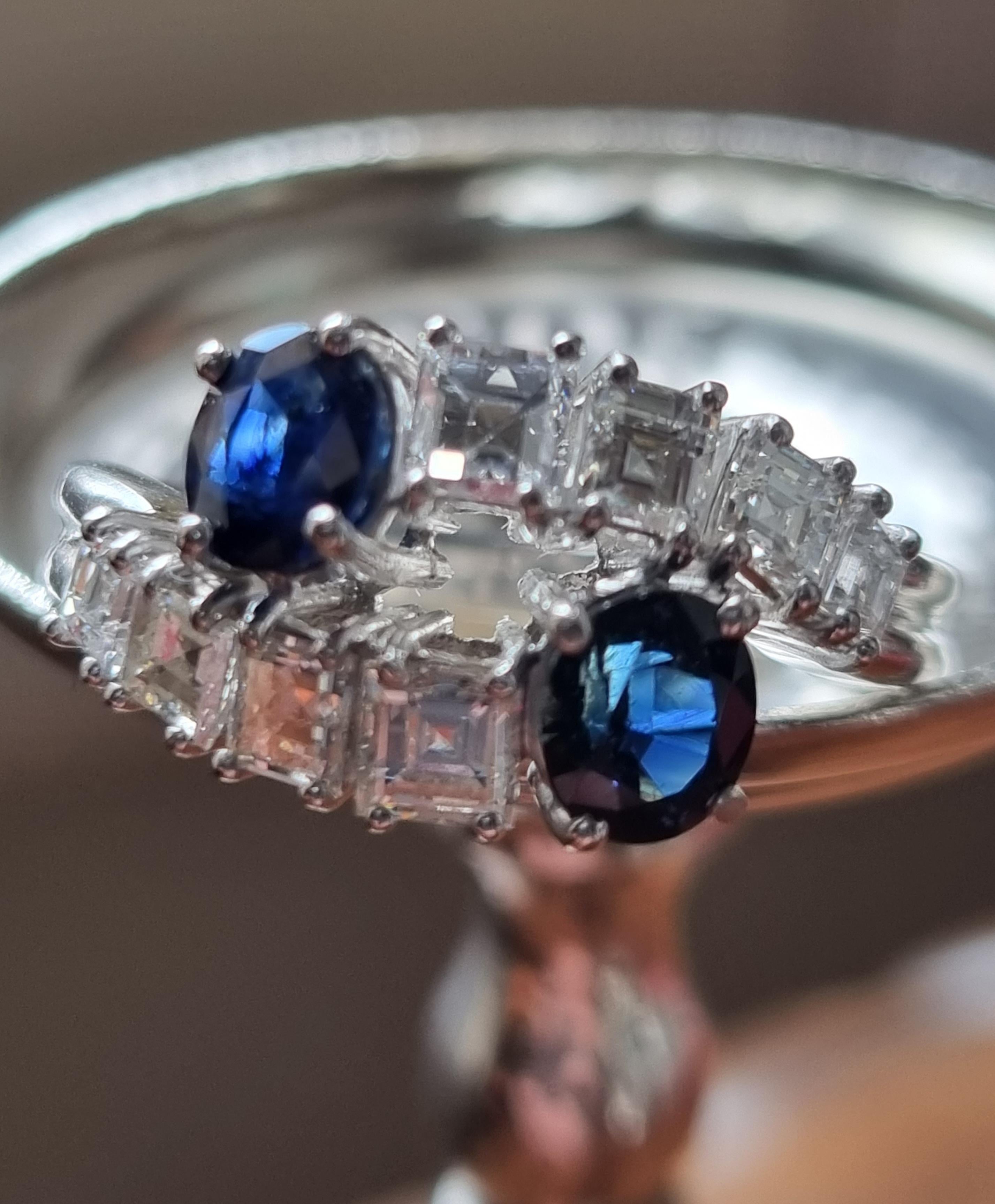 Vintage Blue Sapphire and Diamond Toi et Moi Crossover Ring mounted in 18K white Gold.

An astonishing icon of modern romanticism, this Toi et Moi engagement ring showcases two complementary ethical stones lending this jewel an incomparable