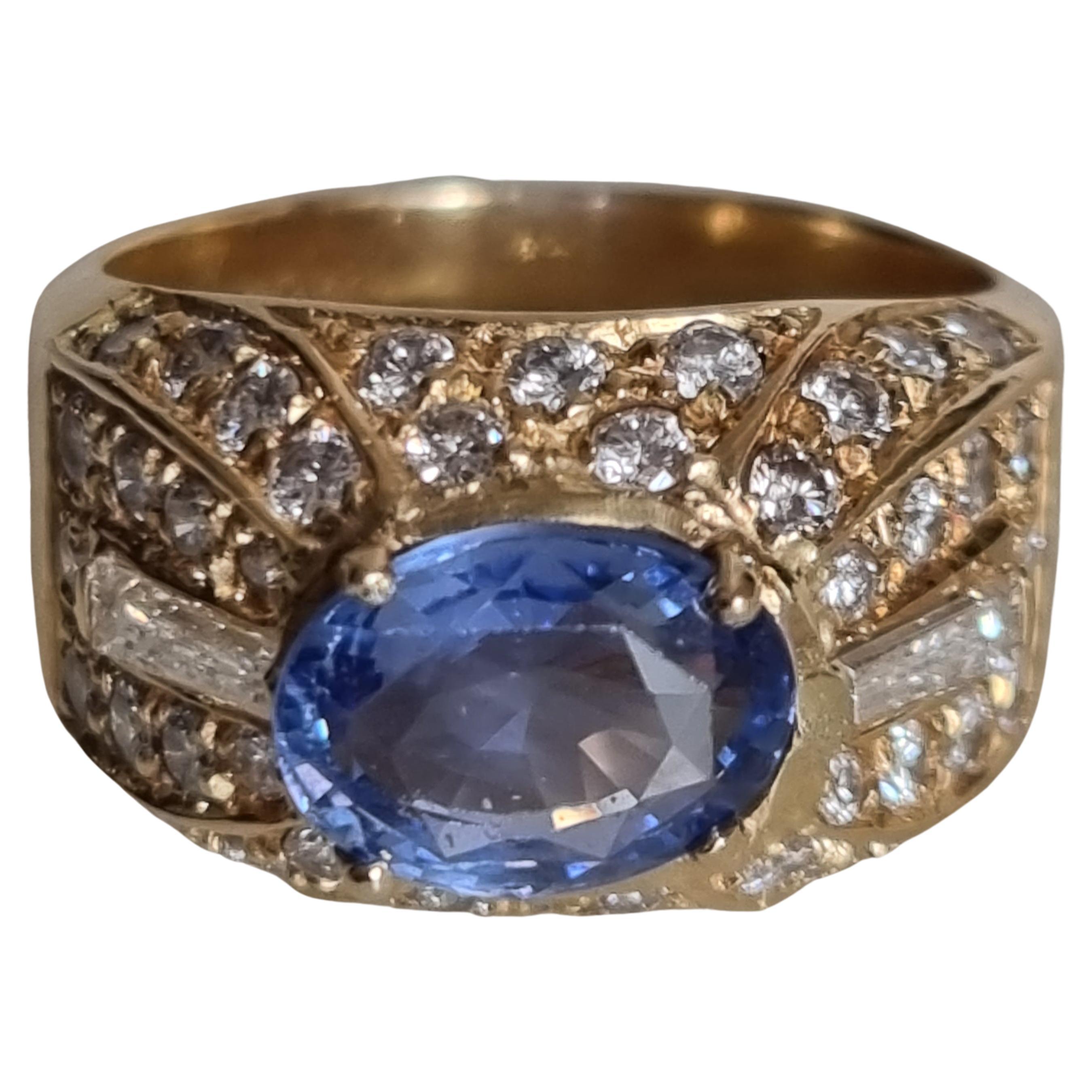Vintage Blue Sapphire and Diamond Bombé Ring, signed by FÜRST (Rome) in 18K yellow Gold.
A vintage blue sapphire and diamond bombé ring, set with an oval cut sapphire, weighing 2.10ct, in the centre (8.80 X 6.88 X 4.31mm), with diamond set round 46