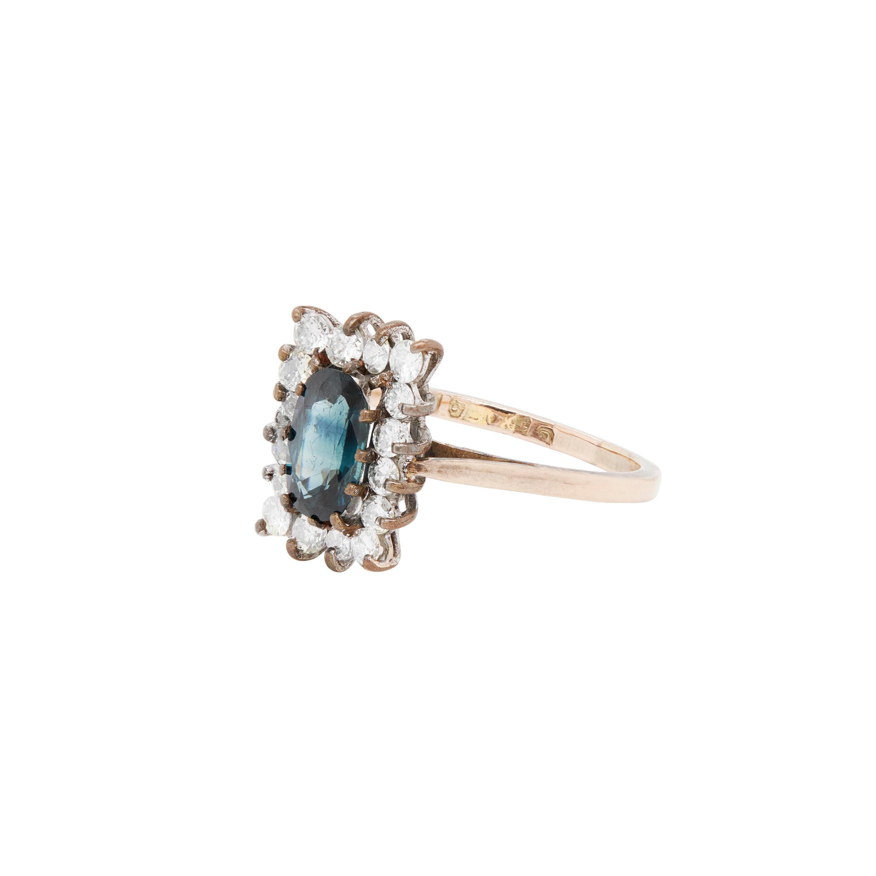 This stunning vintage sapphire and diamond cluster ring would be equally perfect as an engagement ring, or as a right hand ring.

A sumptuous oval sapphire weighing an estimated 1.25 carats or more, is discretely claw-set into this gorgeous