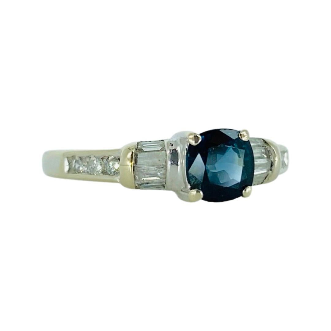 Vintage Blue Sapphire and Diamonds Ring 14k White Gold. The center blue sapphire weights approx 0.90ct and features tapered baguette diamonds and round diamonds totaling approx 0.25ct 
The ring is a size 6.75 and is made in 14 karat white gold.