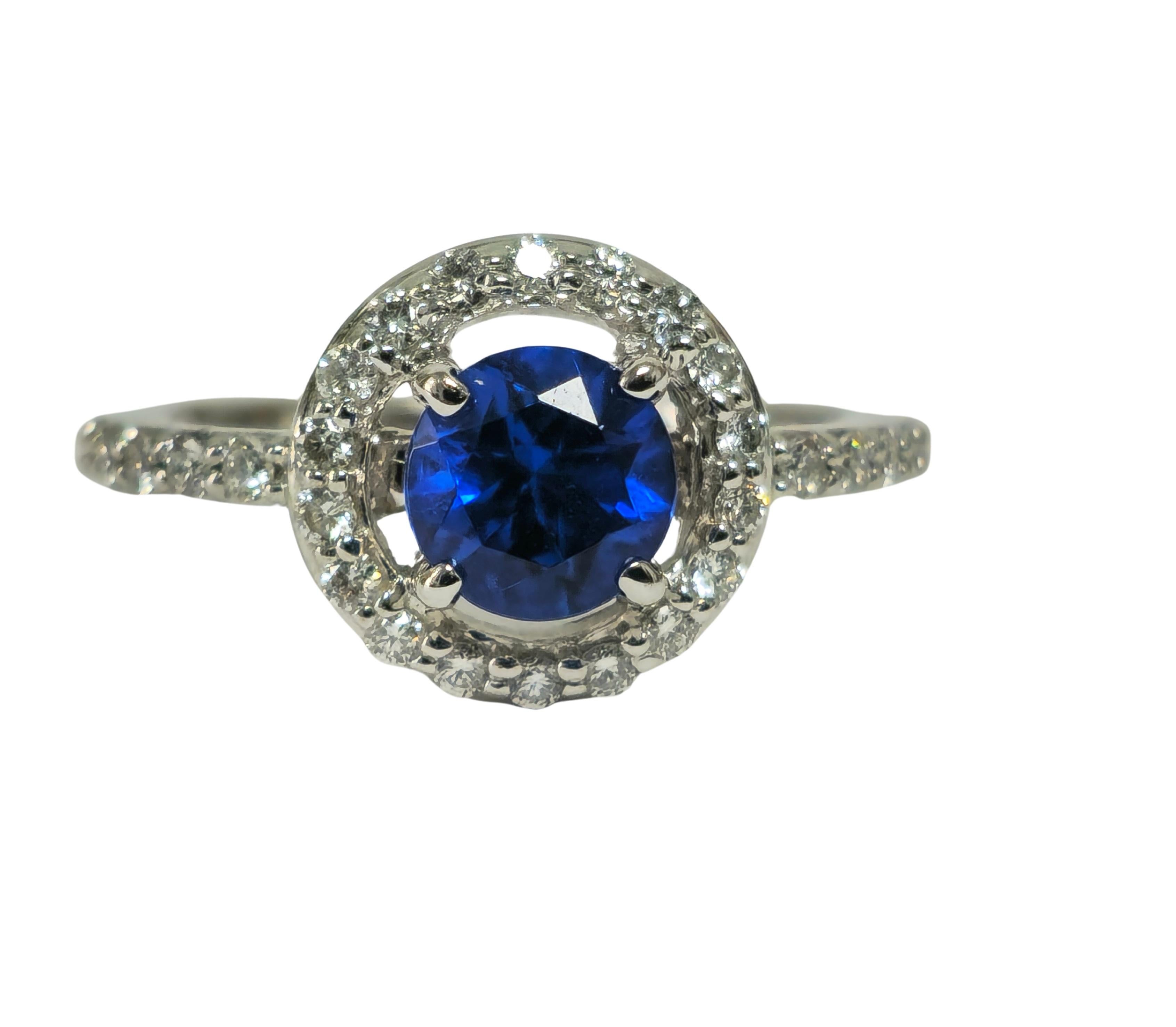 In luminous 14k white gold, our enchanting ring features a total of 0.65 carats of round brilliant cut diamonds, exuding brilliance with VS-SI clarity and F-G color. Gracing the center is a stunning 0.80ct round cut sync blue sapphire, nestled
