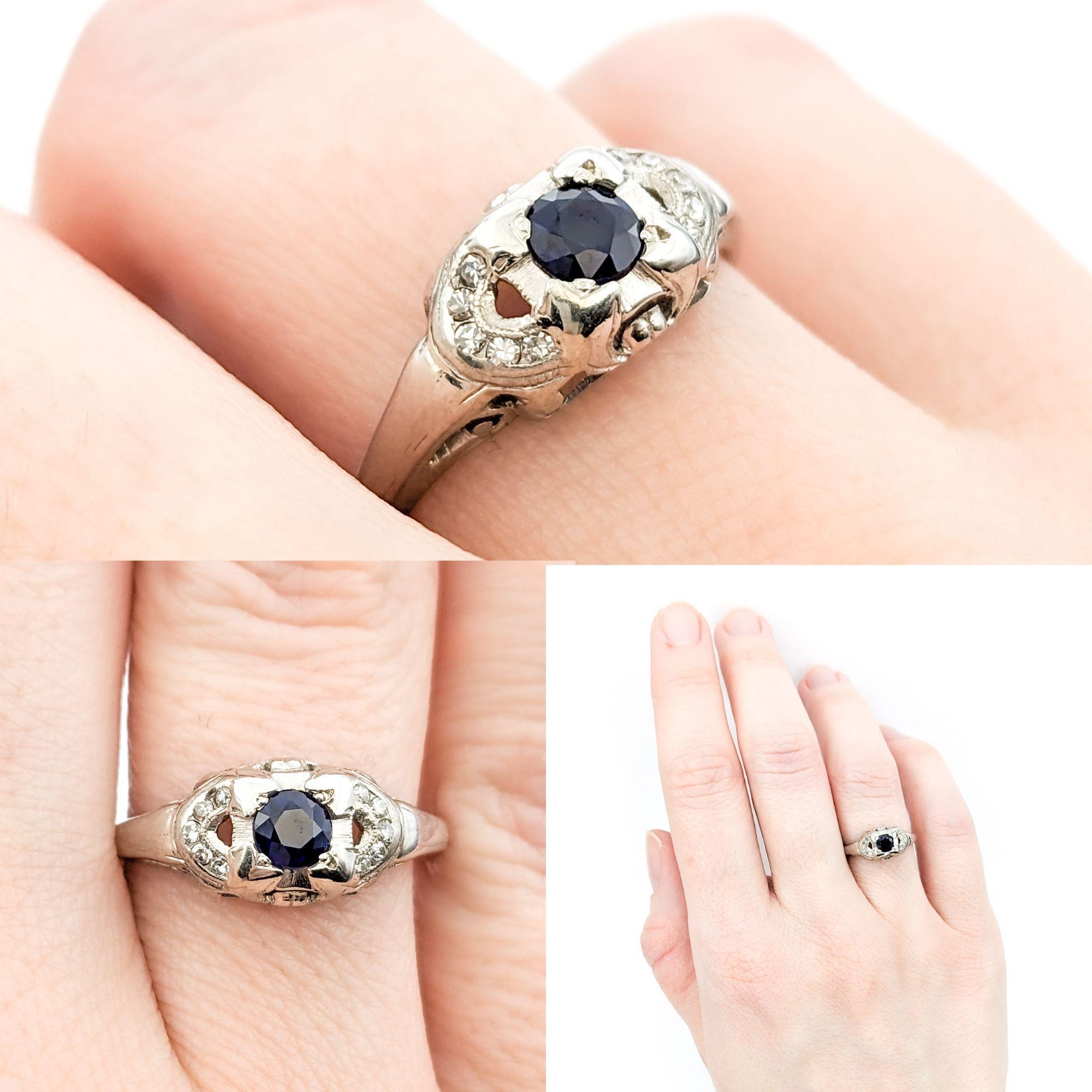 Vintage Blue Sapphire & Diamond Ring In White Gold

Embrace the timeless elegance of this Vintage Ring, expertly crafted in 14kt White Gold. Featuring a .14ctw Round Diamond centerpiece complemented by a .19ct Blue Sapphire, this ring epitomizes the