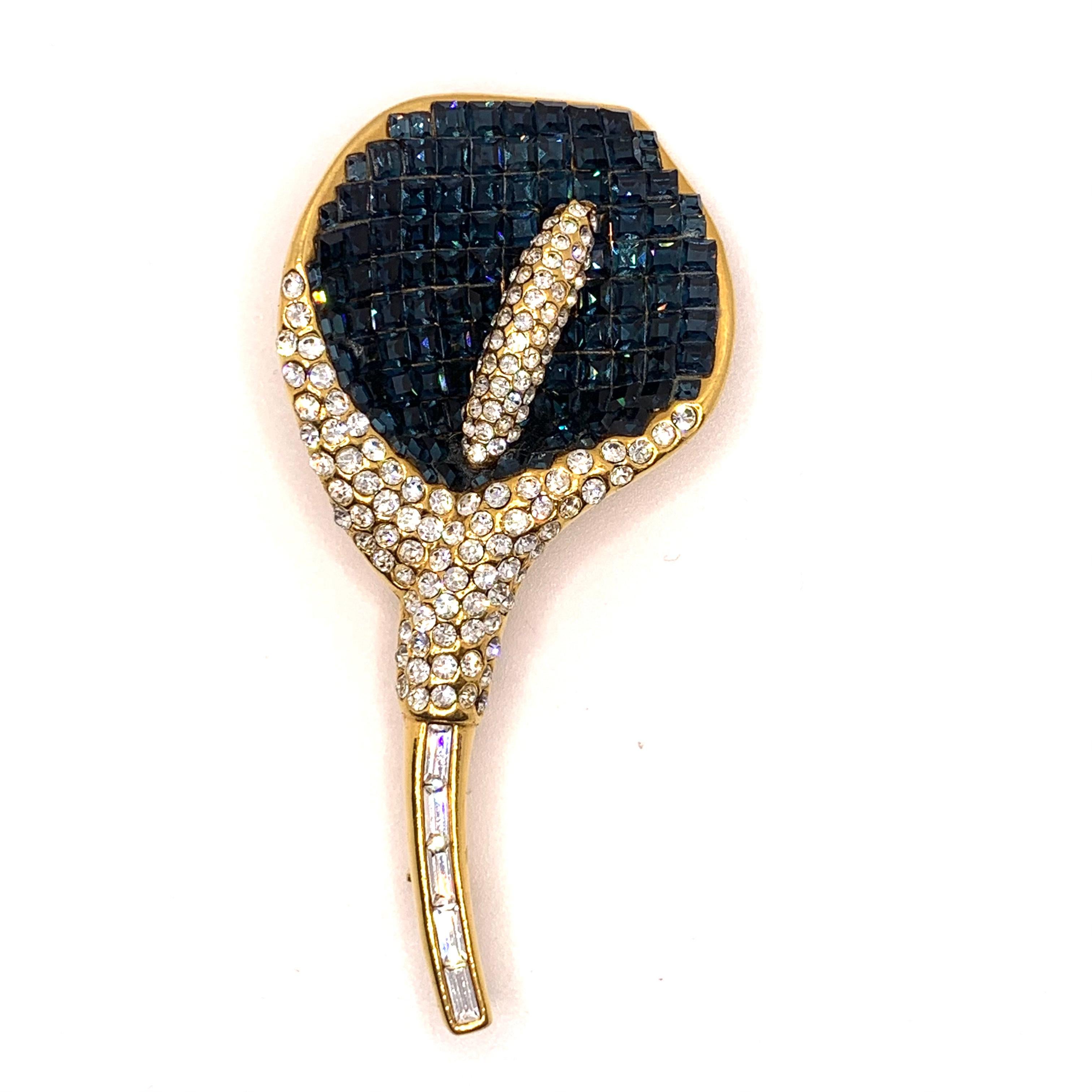 Classic Elegant Vintage Swarovski Clear Crystal Calla Lily Brooch

This vintage brooch features over 240 pieces of blue sapphire and white Swarovski crystals in yellow gold tone. Made in the USA by New York designer brand Jarin.  3