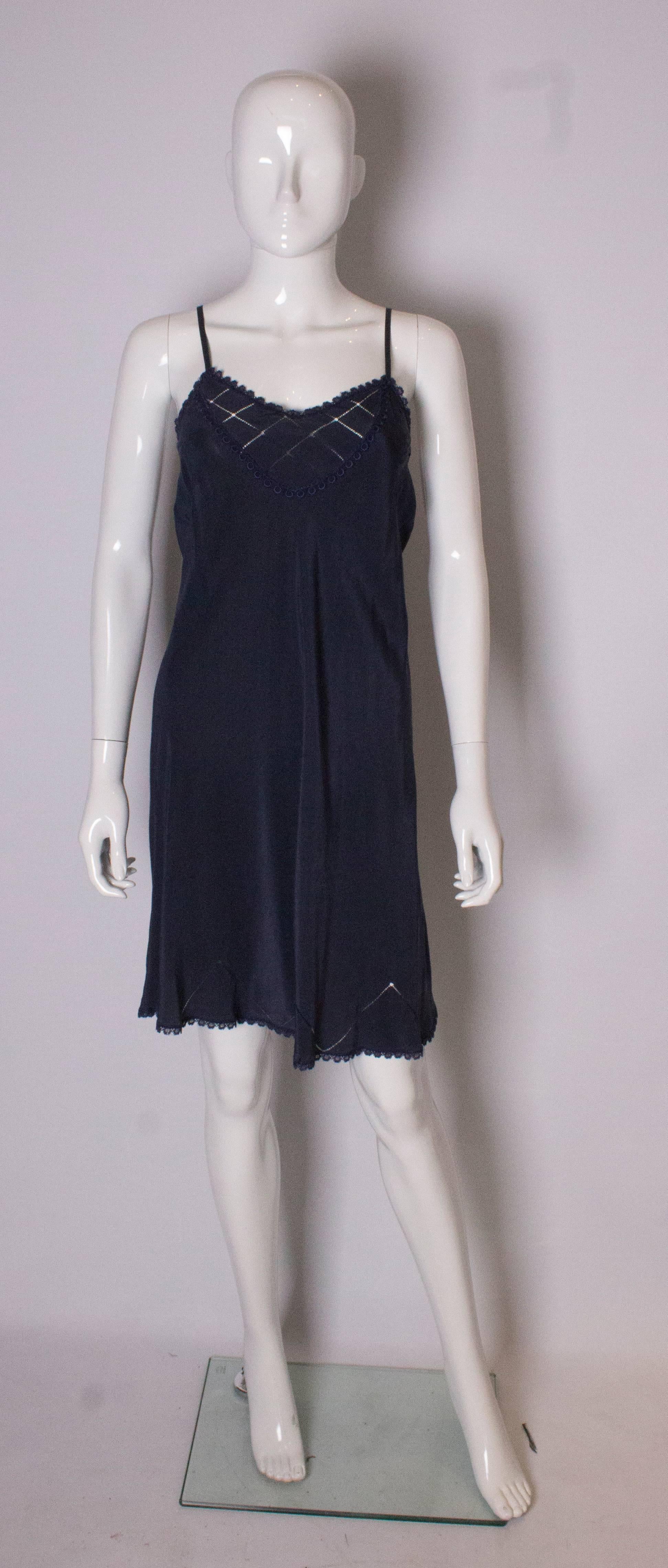 A pretty vintage blue silk slip with detail on the front , neckline and hem.