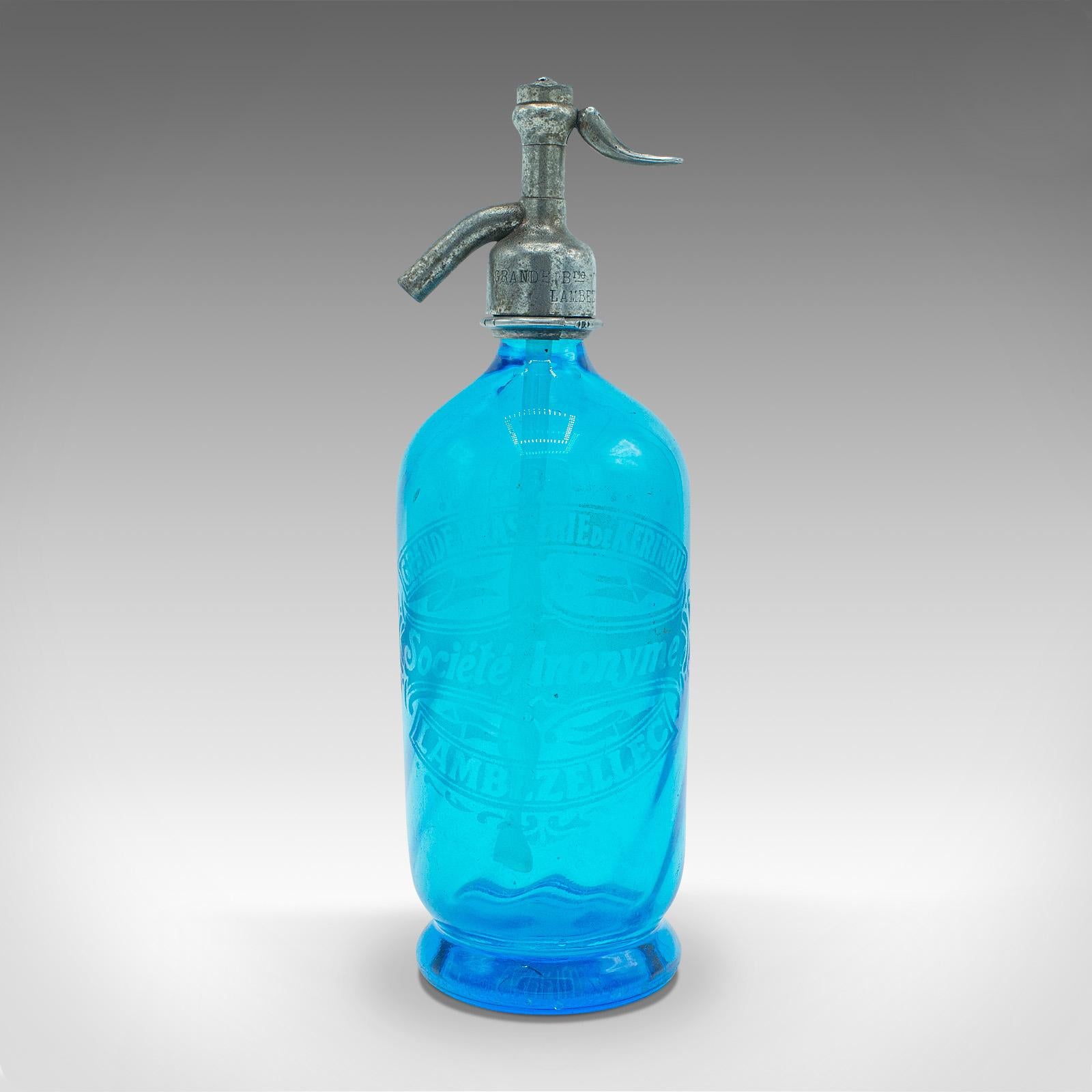 This is a vintage blue soda siphon. A French, decorative glass bistro seltzer bottle, dating to the early 20th century, circa 1930.

Striking glass siphon, with a delightful Continental appeal
Displays a desirable aged patina throughout
Radiant blue