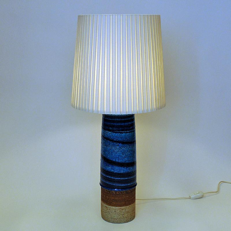 Lovely and tall stoneware table lamp model 8247 with speckled blue, brown and beige glazed colors designed by Swedish designer Inger Persson for Rörstrand in the 1960s. Perfect in every room with its majestic size and rustic vintage look.
Measures:
