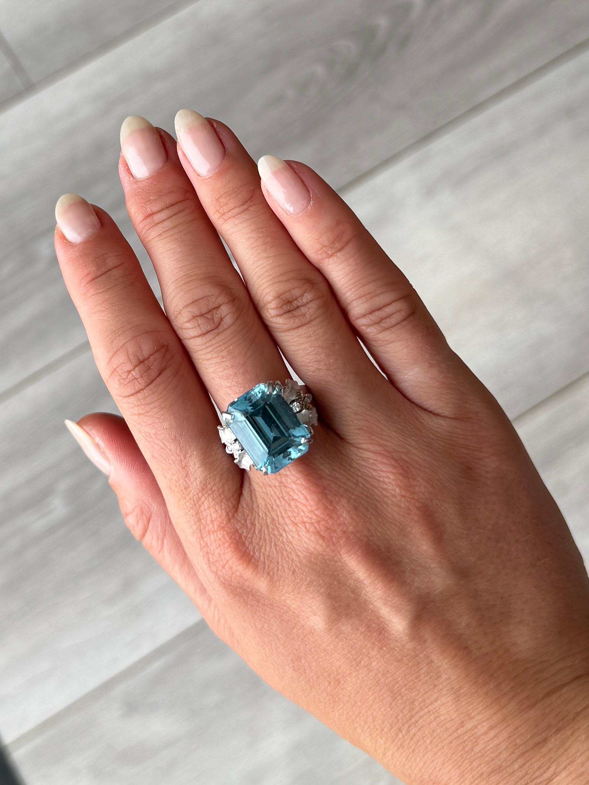 Striking blue topaz set simply and the ring is modelled in 18carat yellow gold. The diamond total of the shoulders is 10pts and they have delicate moulded  leaf detail and the gallery of this ring has gorgeous scroll detail.

Ring Size: Q or 8